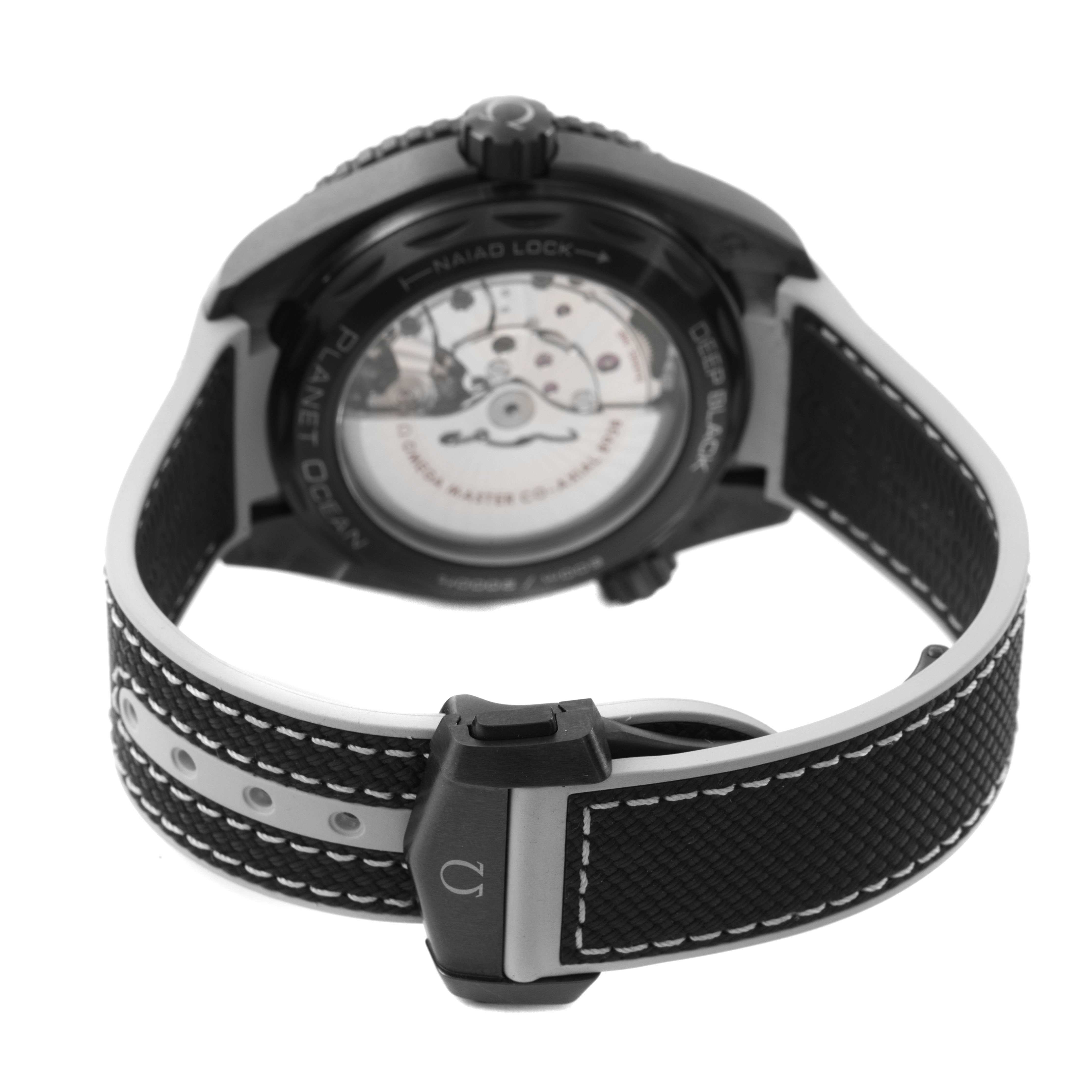 The Omega Planet Ocean 215.92.46.22.01.007 Men's Ceramic Black Dial watch is shown from the back, highlighting the clasp and transparent case back.