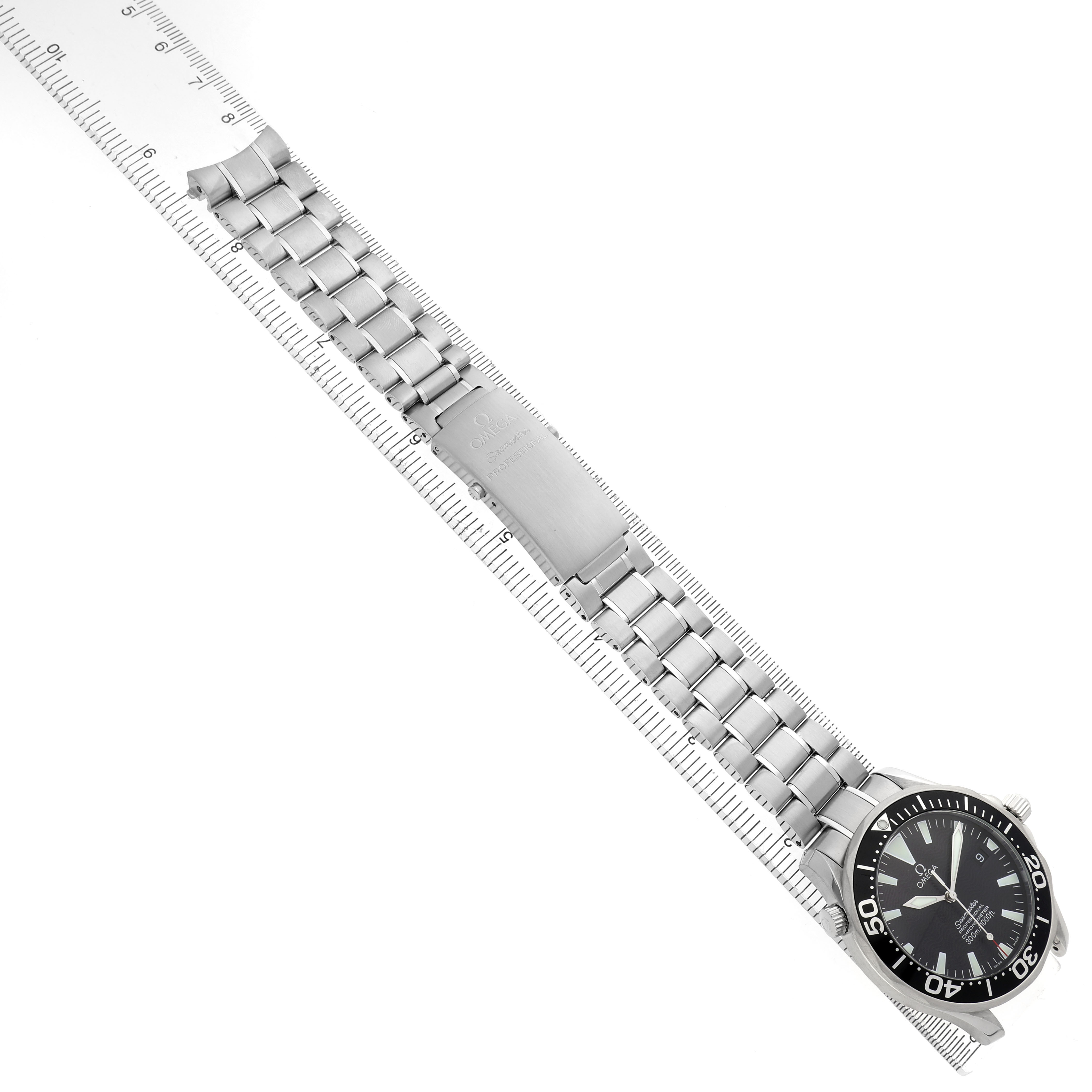 The Omega Seamaster 2254.50.00 Men's Stainless Steel Black Dial watch is shown at an angled top view, highlighting the dial, bezel, and metal bracelet with a ruler alongside.