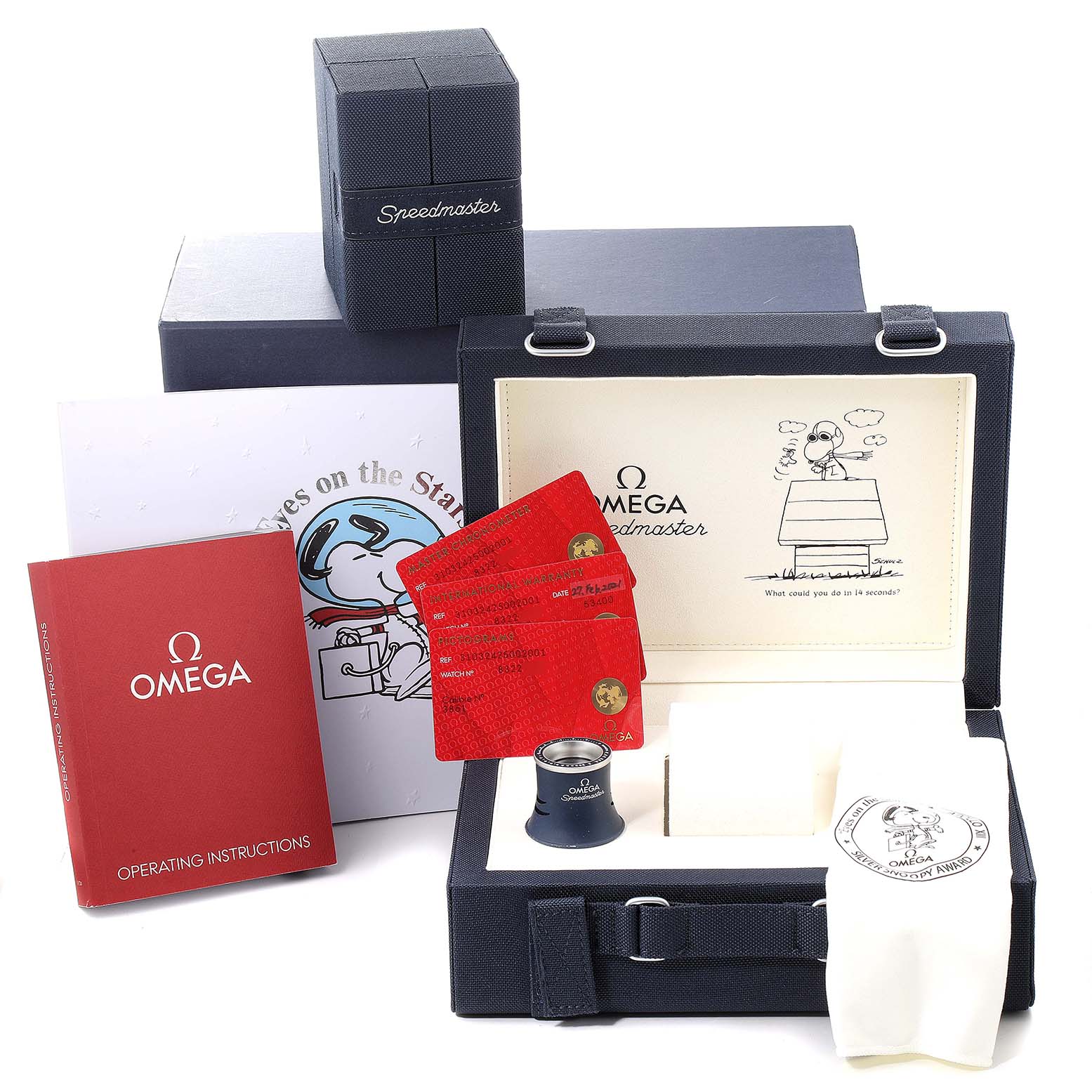 The image shows various accessories for the Omega Speedmaster 310.32.42.50.02.001 Men's Stainless Steel Silver Dial 310.32.42.50.02.001 Men's Stainless Steel Silver Dial, including a box, operating instructions, cards, and a cloth.