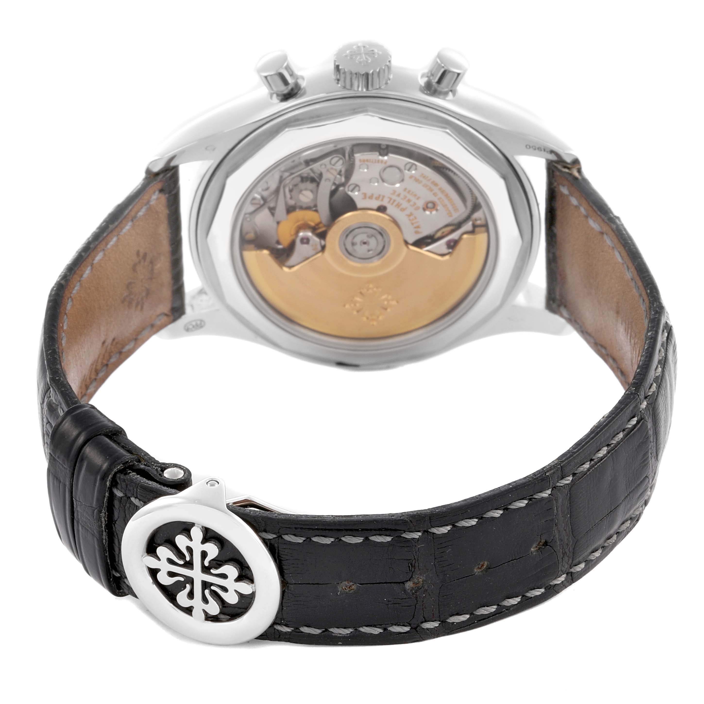 The Patek Philippe Complications 5960P-001 Men's Platinum Grey Dial 5960P-001 Men's Platinum Grey Dial watch is shown from the back, displaying its movement and leather strap with a clasp.
