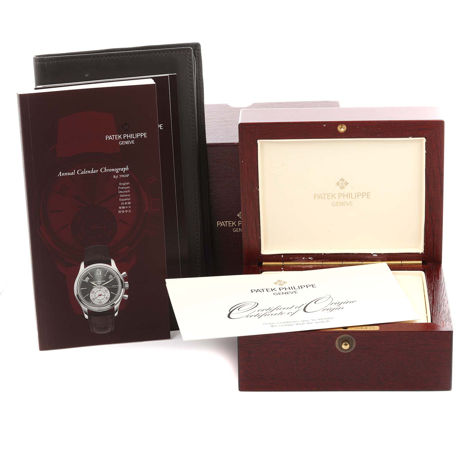 The image shows the packaging and documentation for a Patek Philippe Complications 5960P-001 Men's Platinum Grey Dial 5960P-001 Men's Platinum Grey Dial, including a wooden box and manuals.