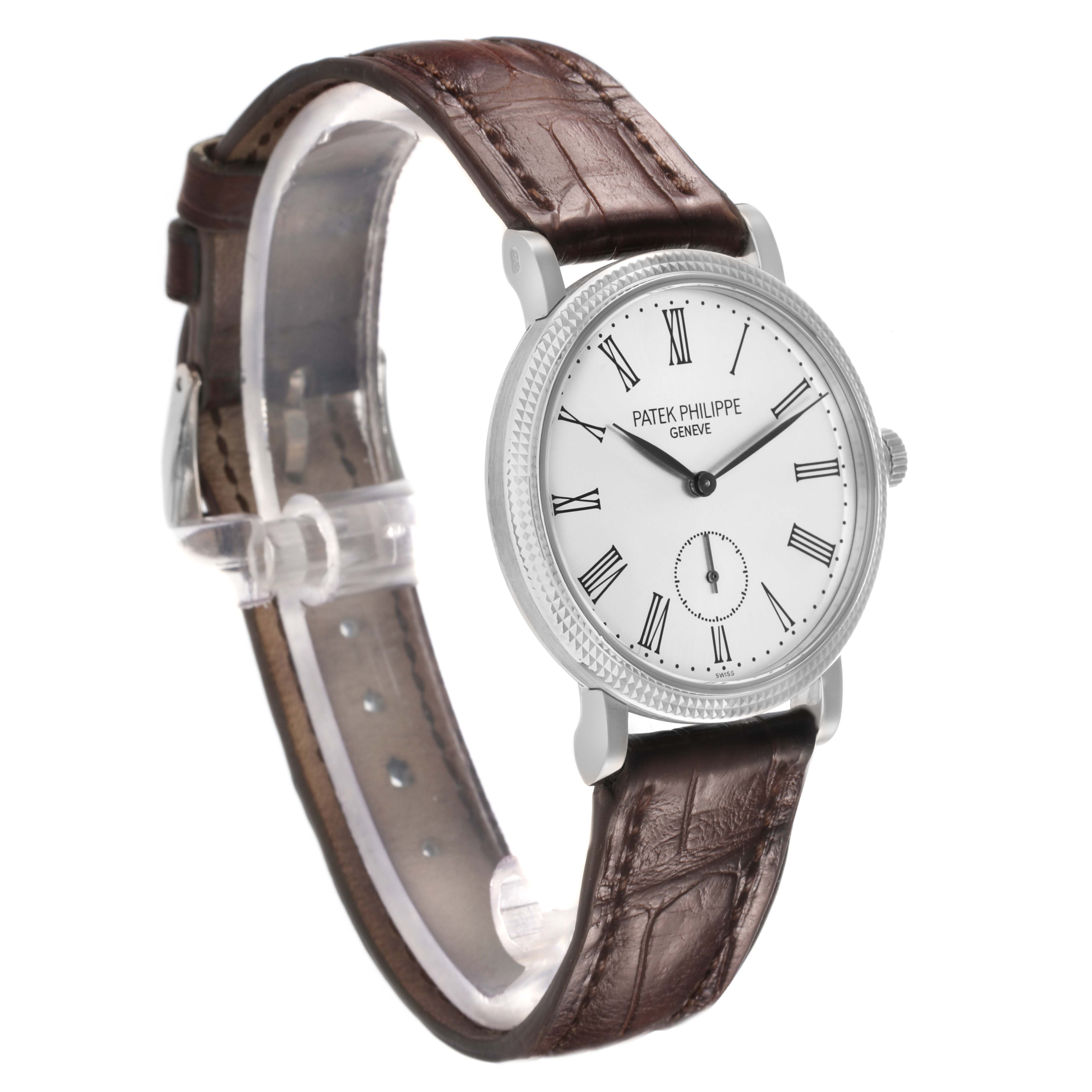 The image shows a side angle of the Patek Philippe Calatrava 7119G Women
s White Gold White Dial watch, highlighting its face, bezel, and leather strap.