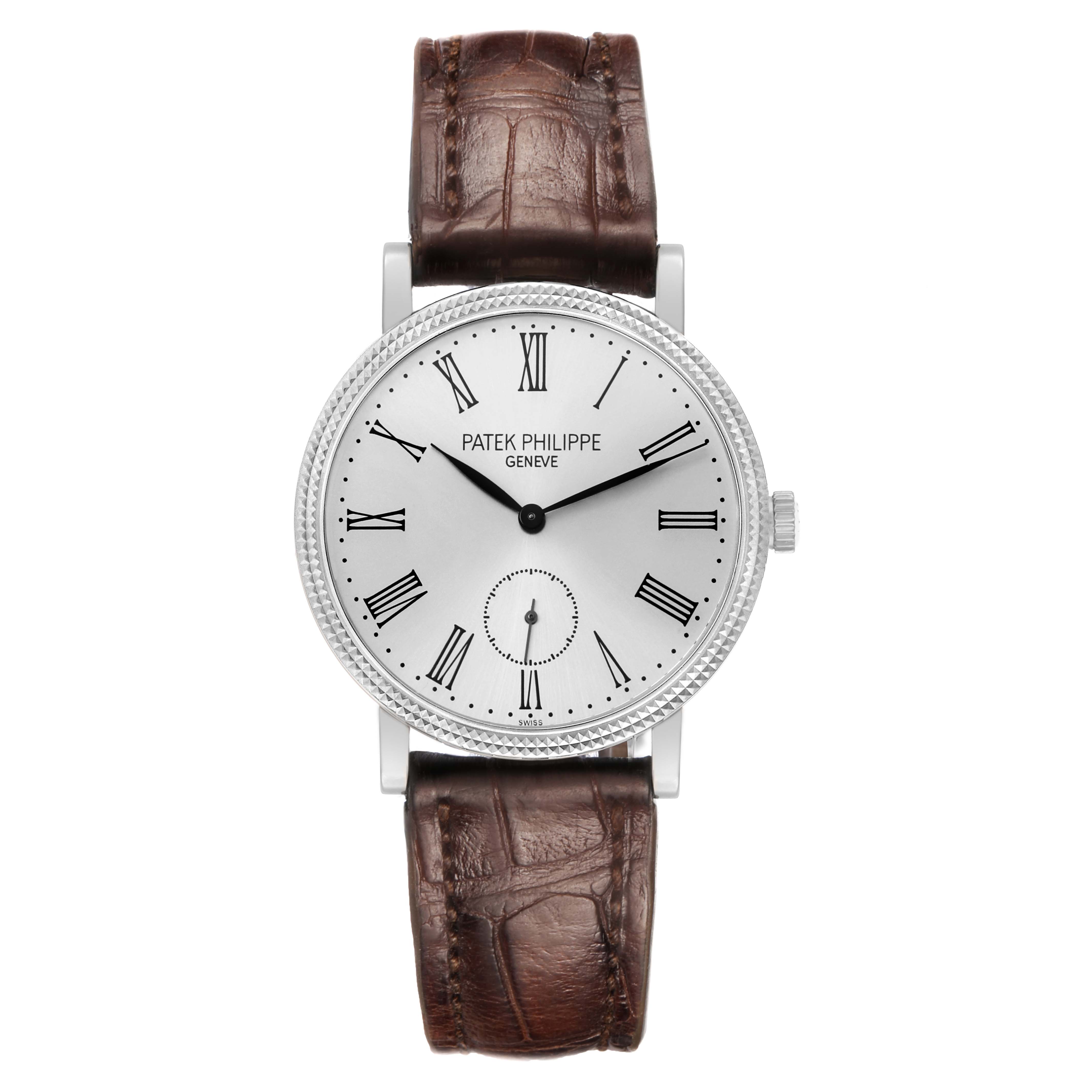 The Patek Philippe Calatrava 7119G Women
s White Gold White Dial watch is shown from a frontal angle, displaying the face, Roman numerals, and brown leather strap.