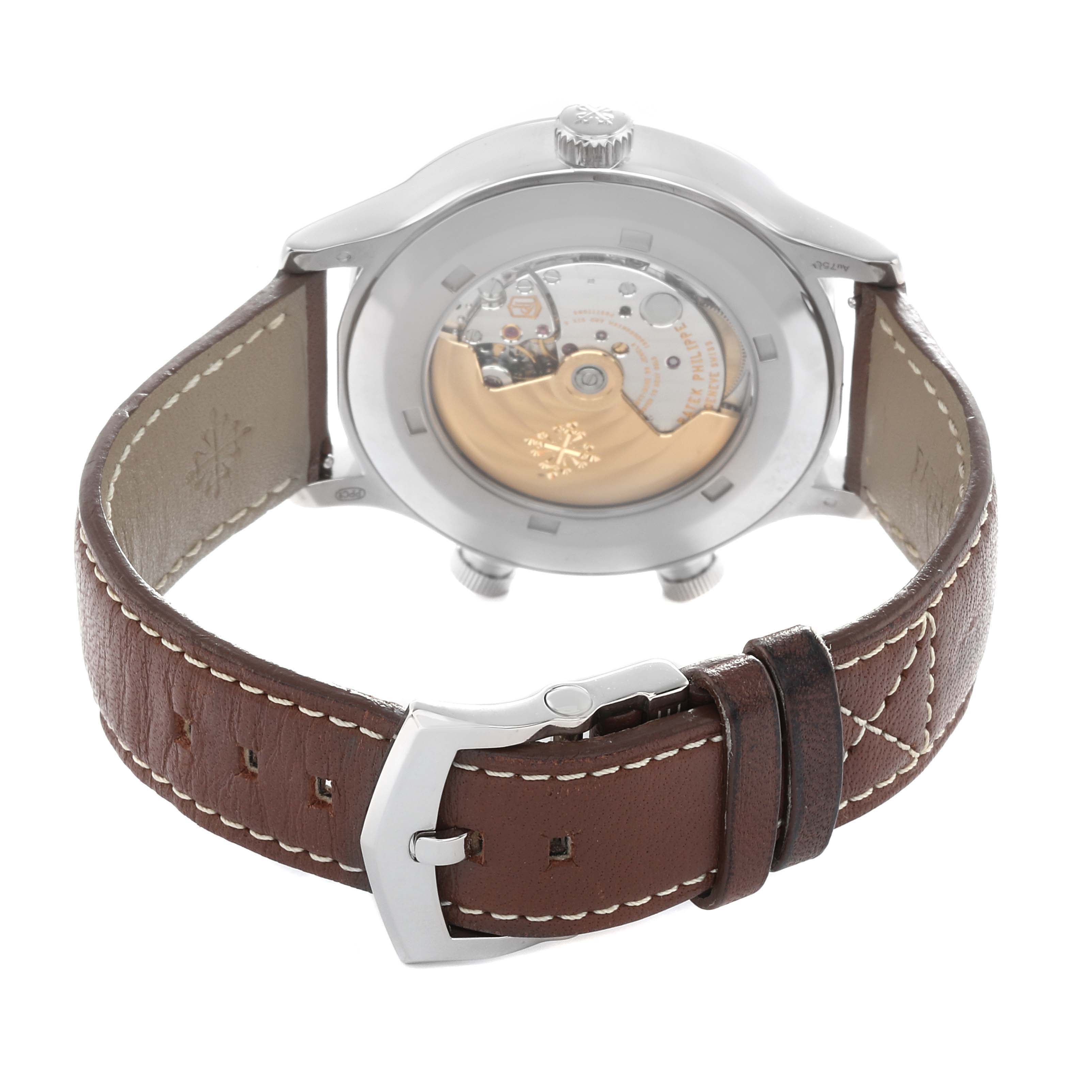 The image shows the back of a Patek Philippe Calatrava 5524G-001 Men
s White Gold Blue Dial, highlighting its transparent case back and brown leather strap with buckle.