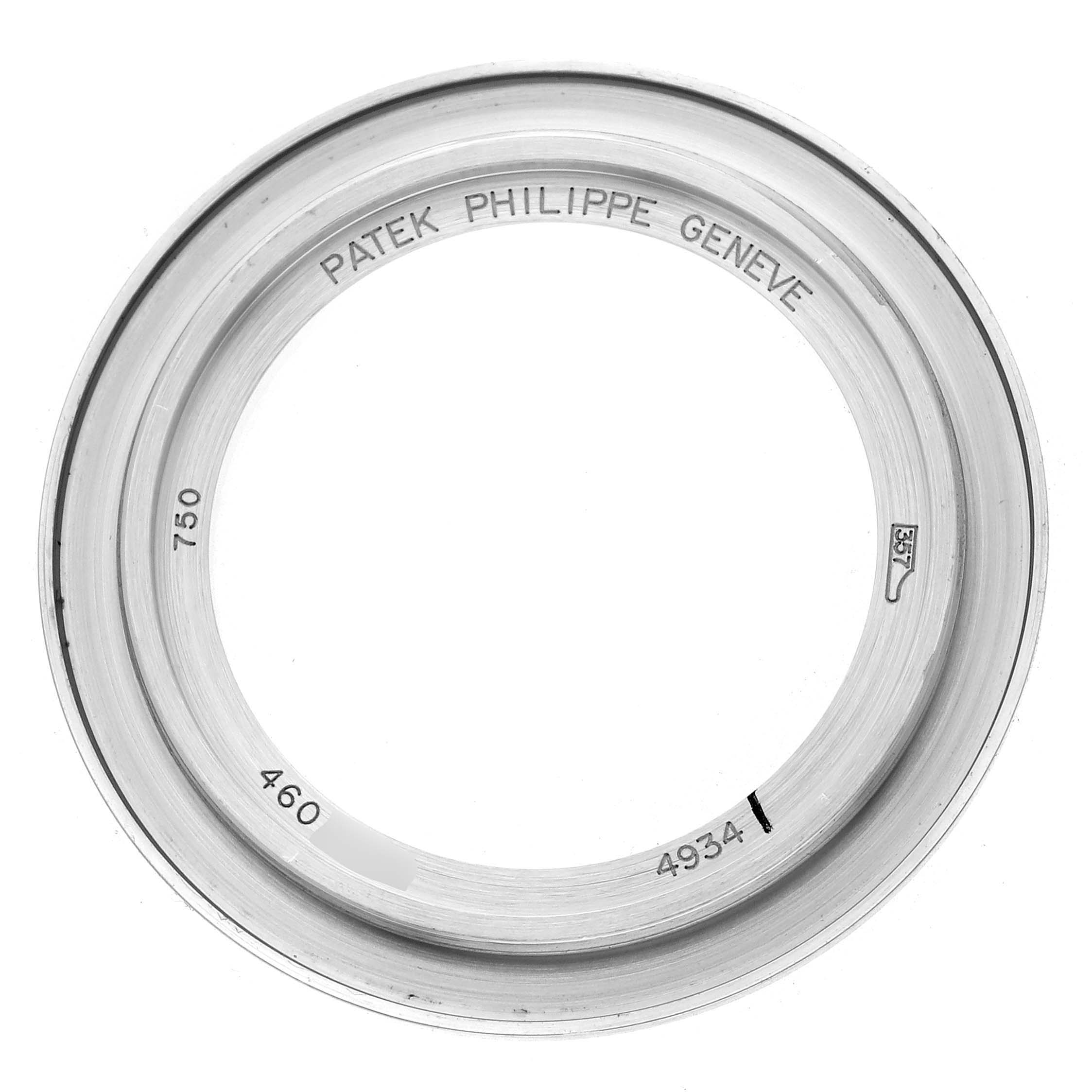 This image shows a bezel from the Patek Philippe Calatrava 4934G-001 Women
s White Gold Mother of Pearl Dial model, viewed from above with engravings visible.