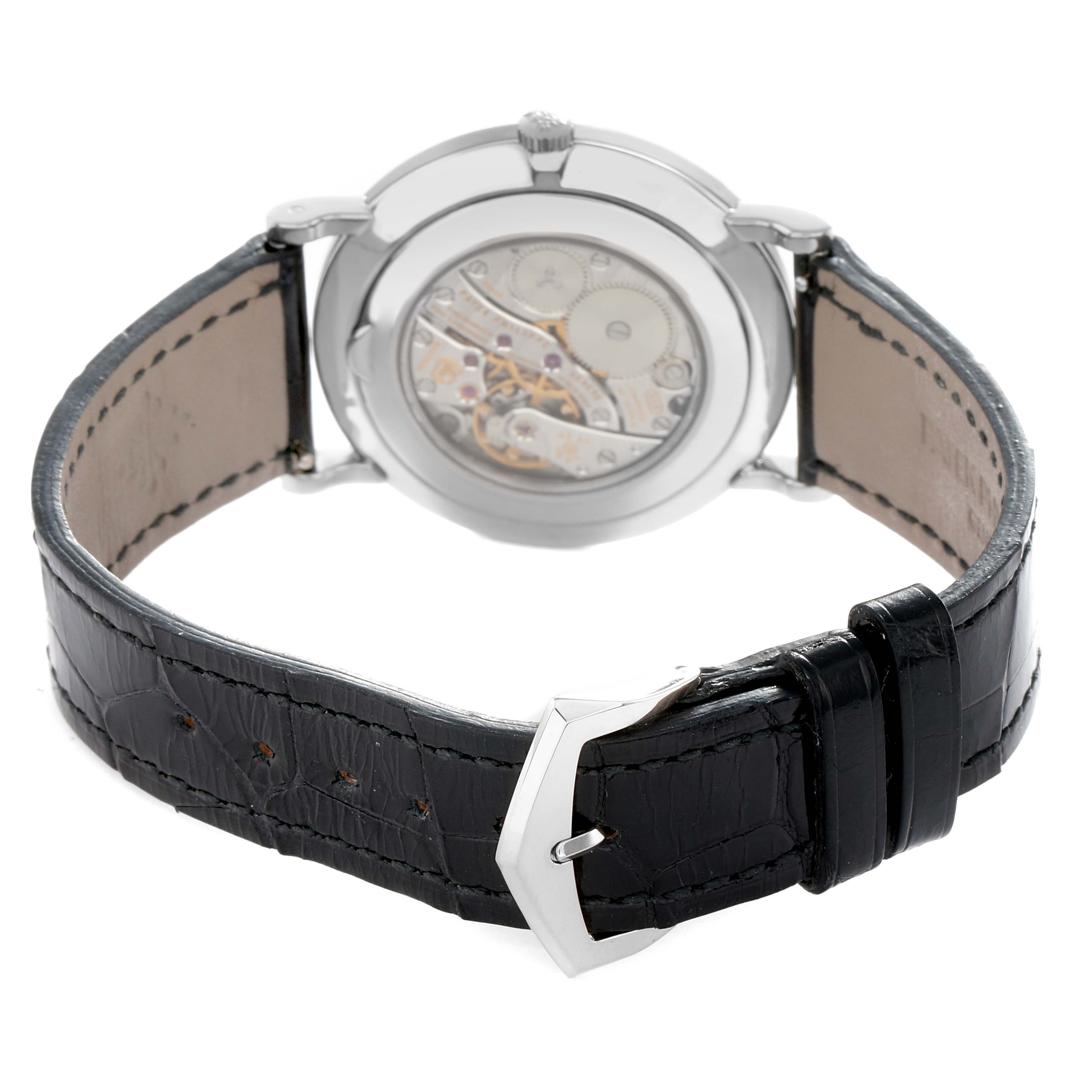 The Patek Philippe Calatrava 5119G-001 Men
s White Gold White Dial watch is shown from the back, highlighting the movement and leather strap with a metal buckle.