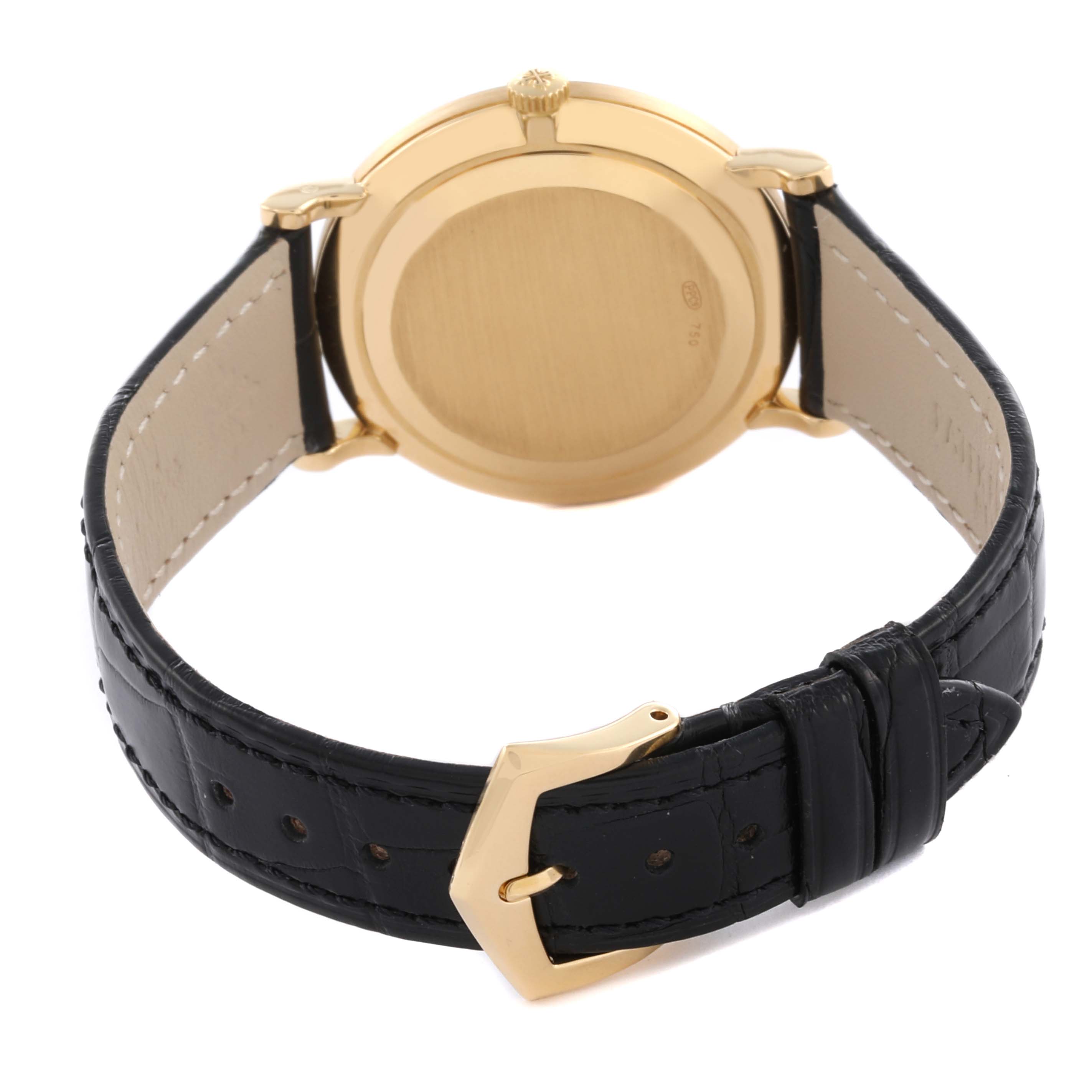 The Patek Philippe Calatrava 3919J Men's Yellow Gold White Dial 3919J Men's Yellow Gold White Dial watch is shown from the rear, displaying the back case and black leather strap with a gold buckle.