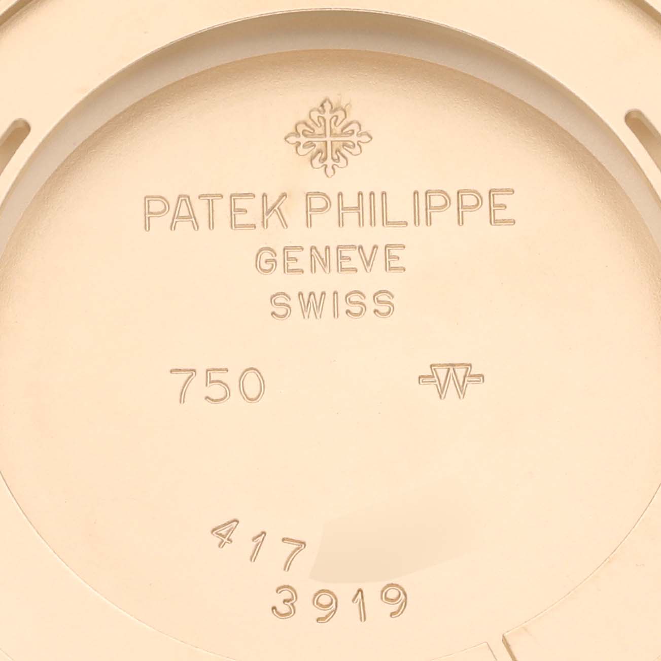 The image shows the back case of a Patek Philippe Calatrava 3919J Men's Yellow Gold White Dial 3919J Men's Yellow Gold White Dial watch, featuring inscriptions and hallmarks.