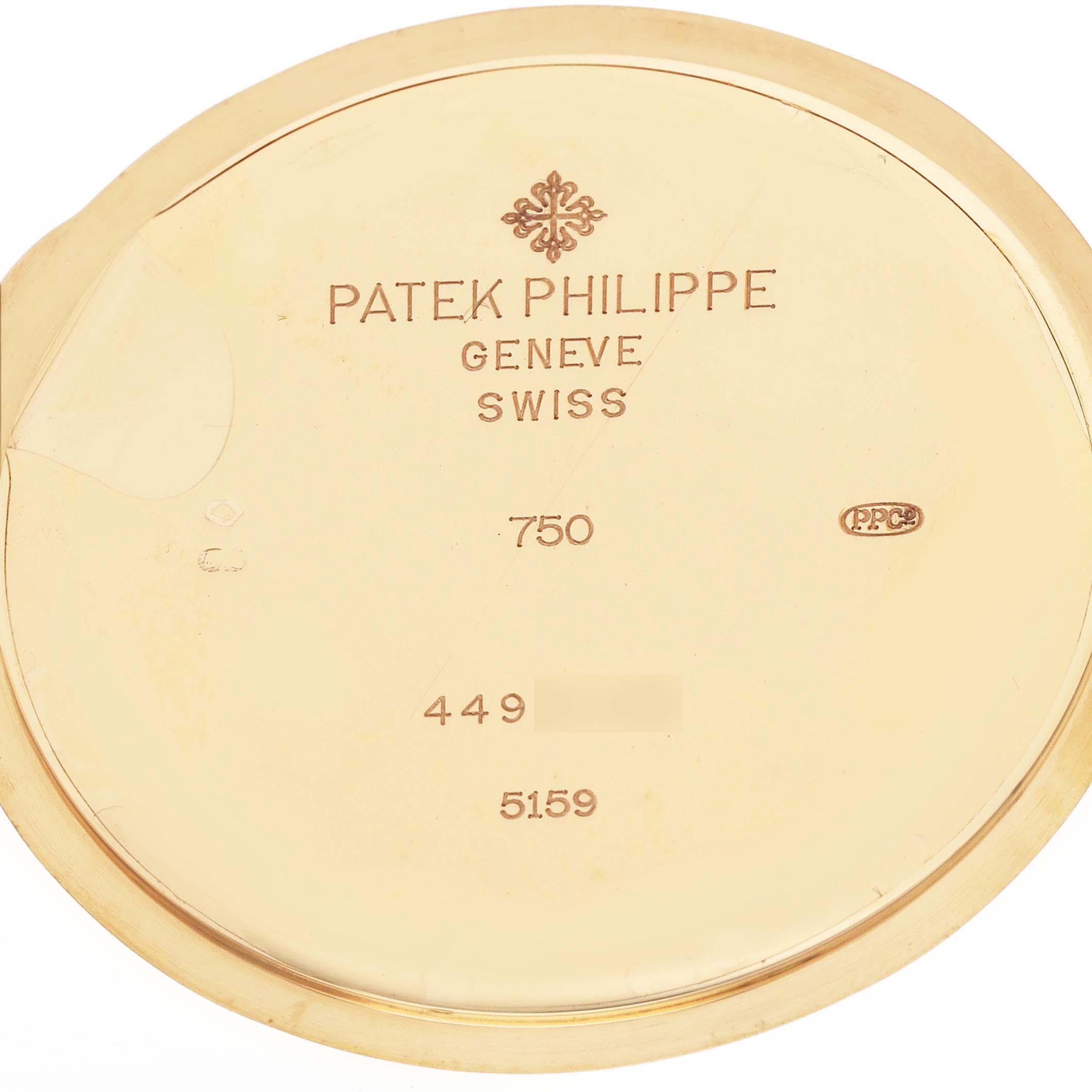 The image shows the interior of the Patek Philippe Complications 5159J-001 Men
s Yellow Gold Silver Dial model case back, featuring engravings and hallmarks.