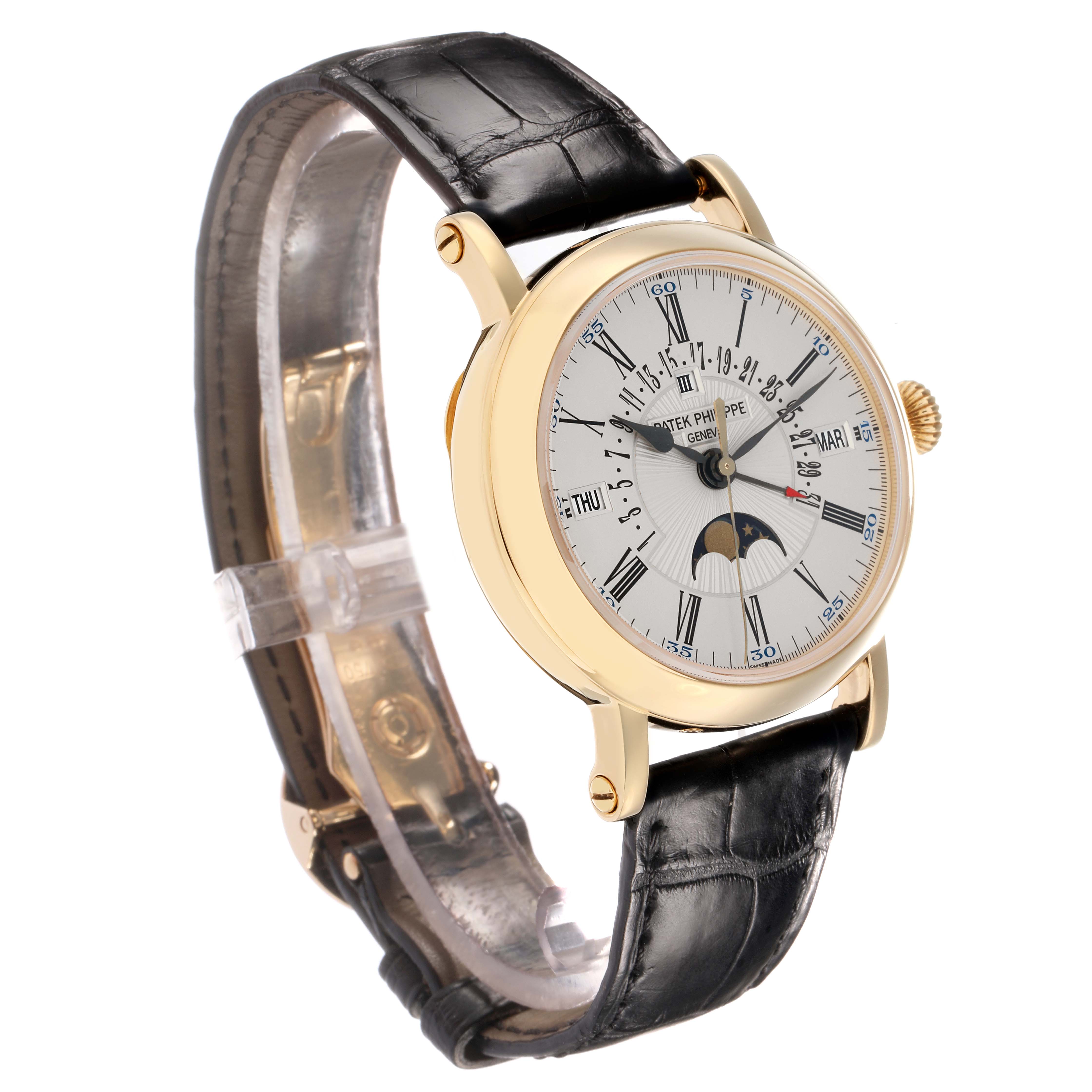 The Patek Philippe Complications 5159J-001 Men
s Yellow Gold Silver Dial model is shown from a three-quarter angle, highlighting the dial, crown, and leather strap.