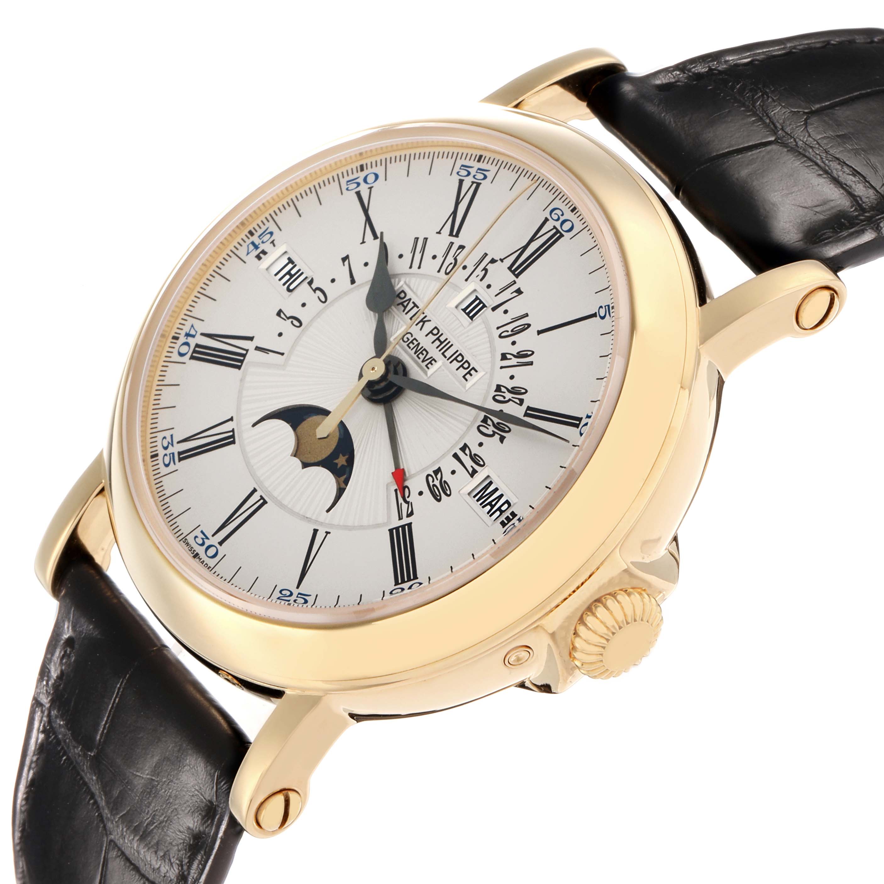 The Patek Philippe Complications 5159J-001 Men
s Yellow Gold Silver Dial watch is shown at an angle displaying the face, crown, lugs, and part of the leather strap.