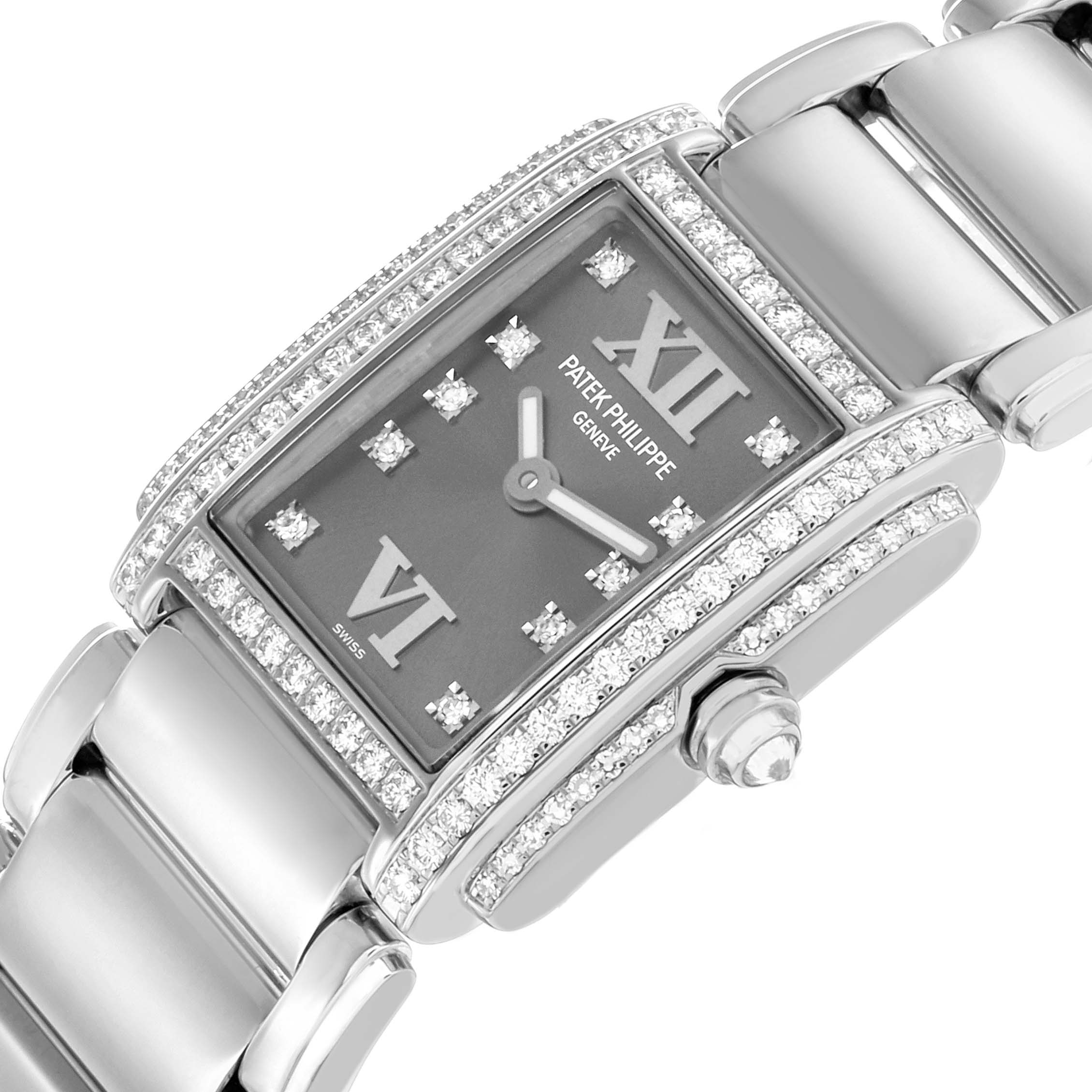 The Patek Philippe Twenty-4 4908G Women
s White Gold Silver Dial watch is shown at an angled view, highlighting its diamond-adorned rectangular face and bracelet links.