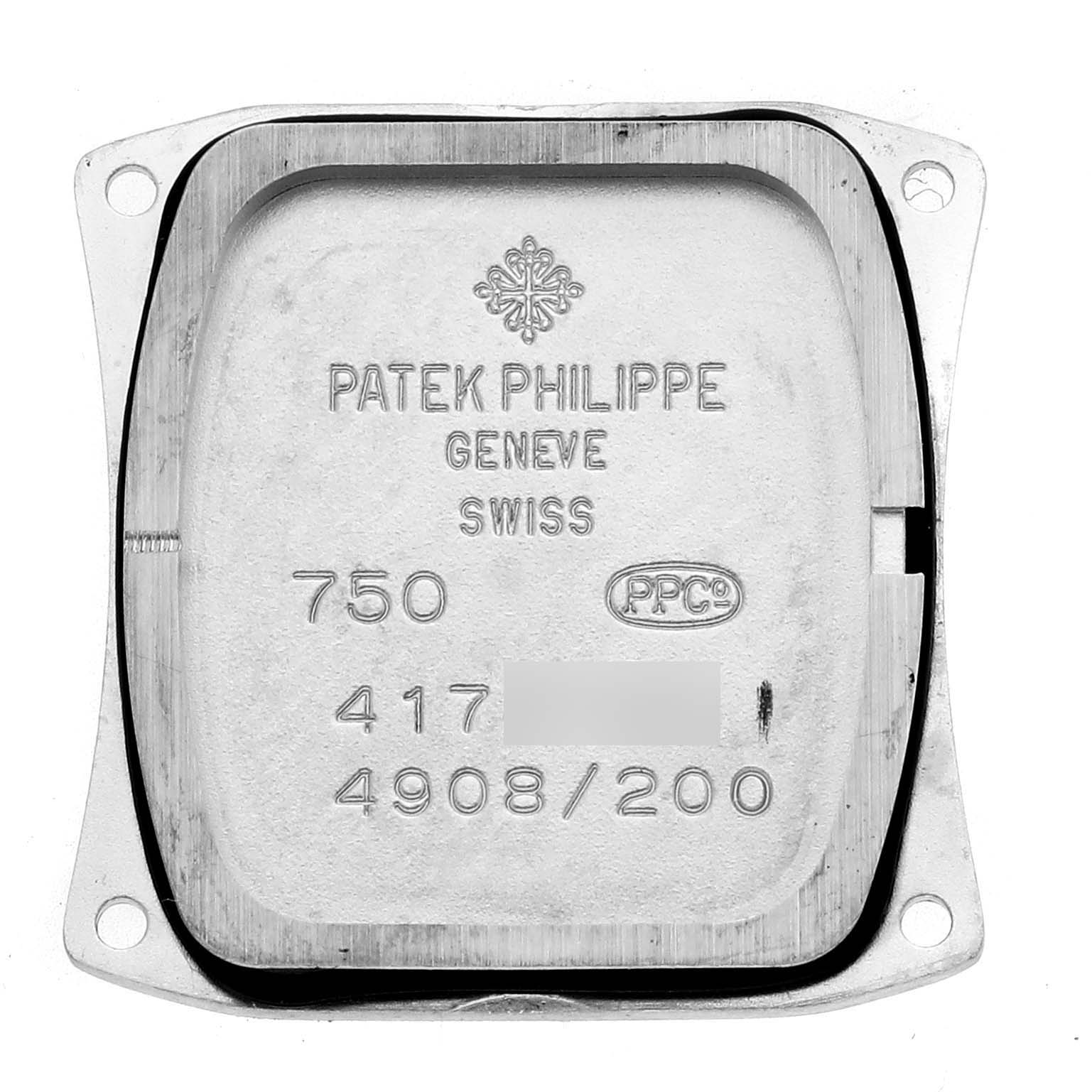 The image shows the case back interior of a Patek Philippe Twenty-4 4908G Women
s White Gold Silver Dial watch, displaying engravings and hallmarks.