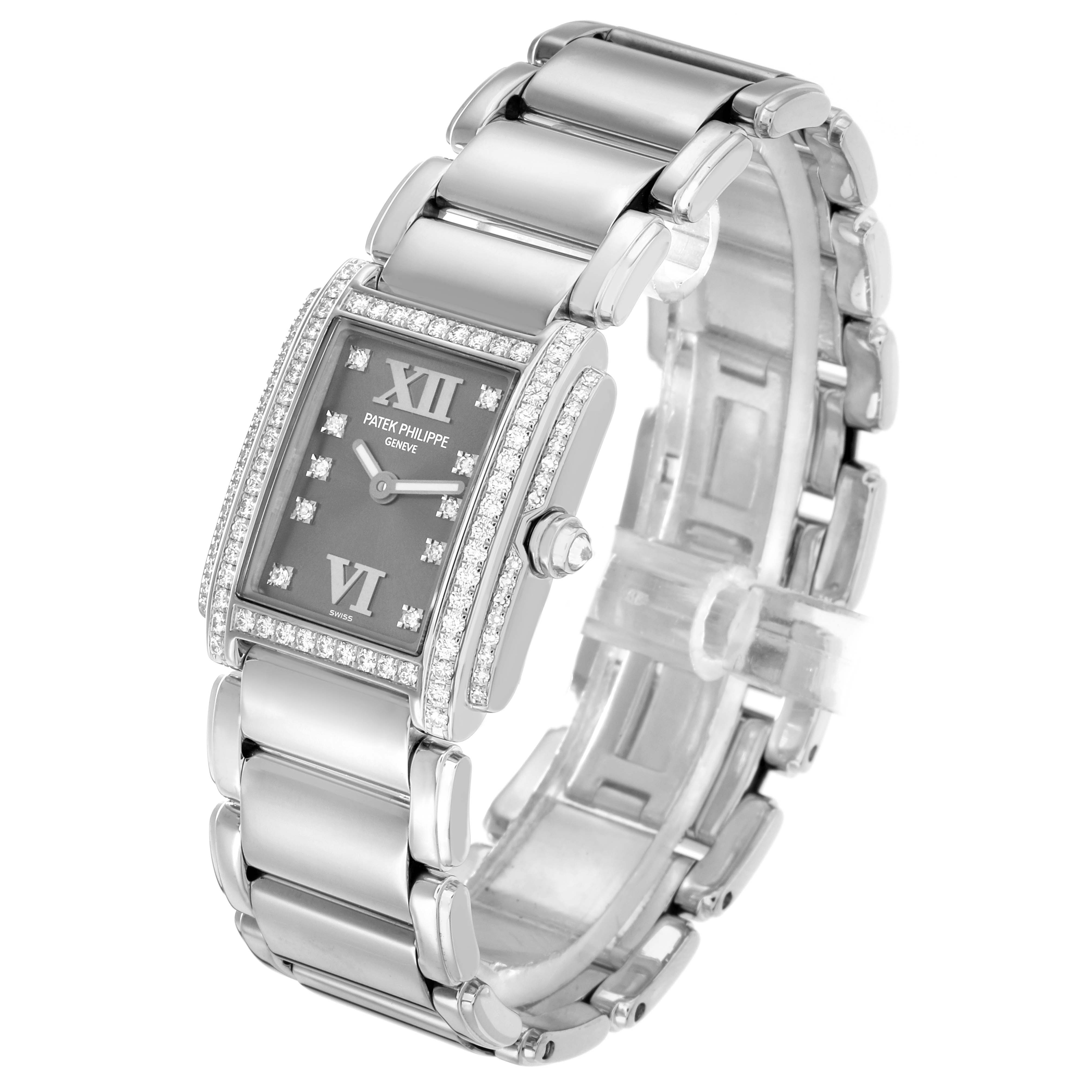The Patek Philippe Twenty-4 4908G Women
s White Gold Silver Dial watch is shown at an angled view, highlighting its rectangular face, diamond bezel, and metal bracelet.