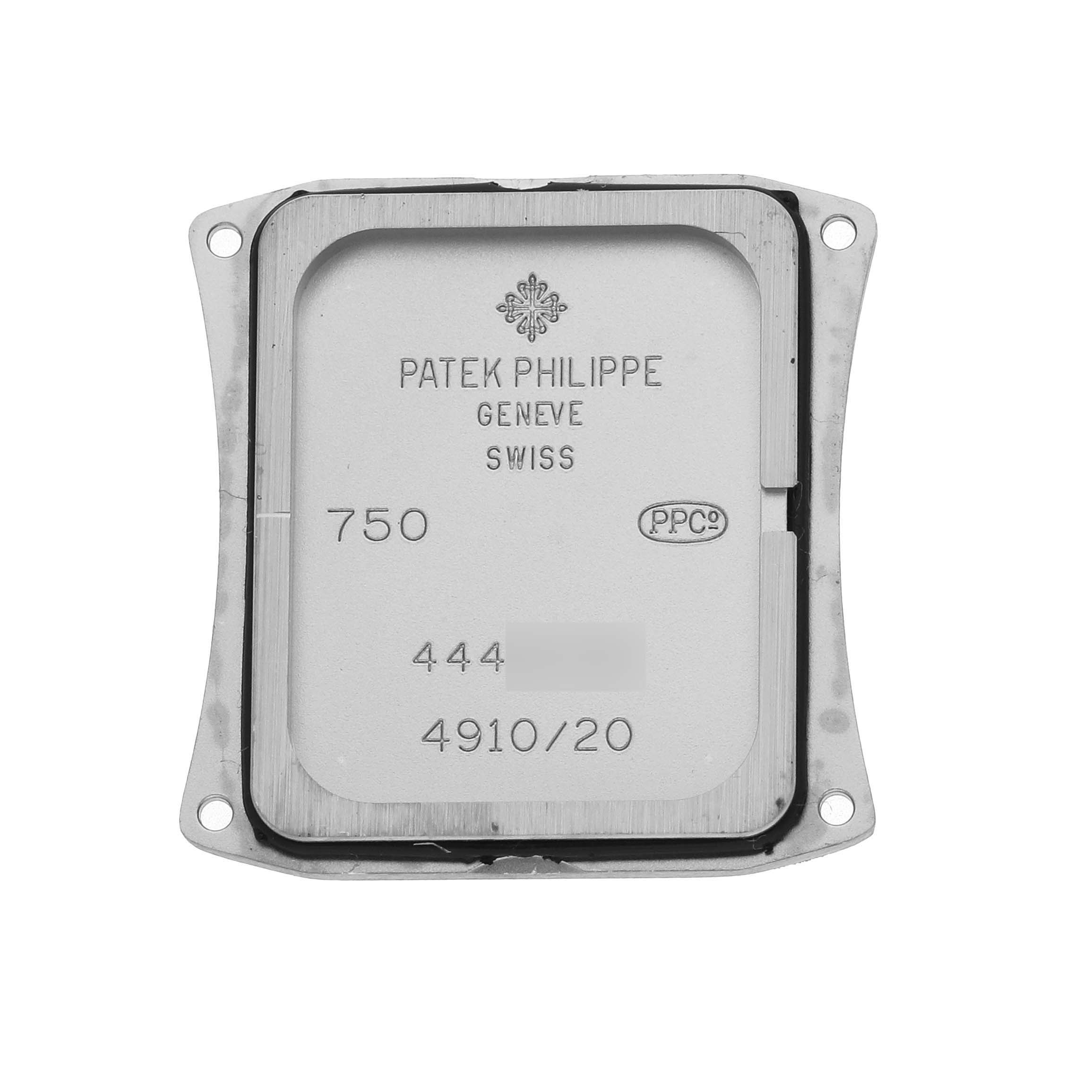 The image shows the back plate of a Patek Philippe Twenty-4 4910/20G-001 Women's White Gold Silver Dial watch, detailing engravings and certifications.