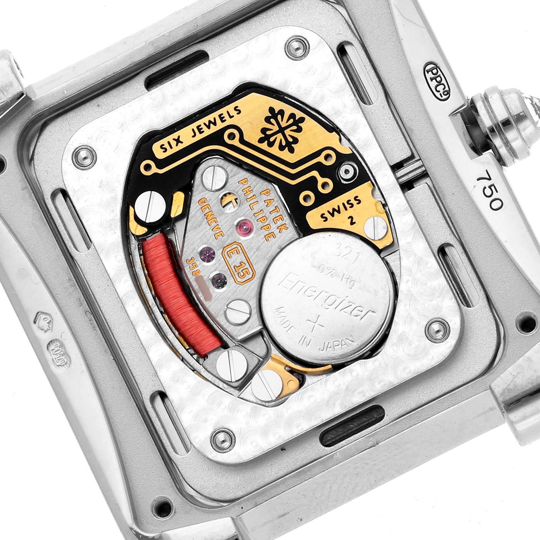 The image shows the movement and battery of a Patek Philippe Twenty-4 4910/20G-001 Women's White Gold Silver Dial watch from a back angle.