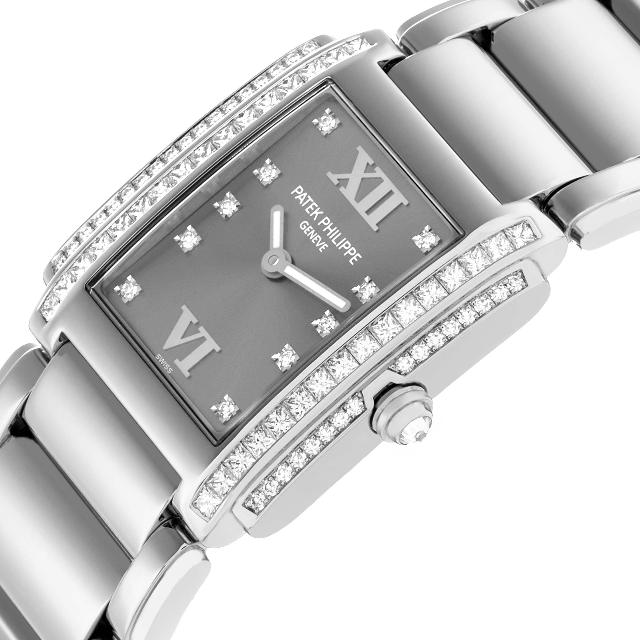 The Patek Philippe Twenty-4 4910/20G-001 Women's White Gold Silver Dial watch is shown at an angled view, highlighting the diamond-set bezel, dial, and part of the bracelet.