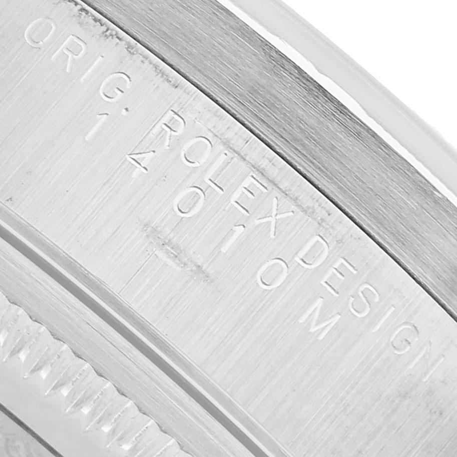 The image shows a close-up of the case edge of a Rolex Air-King 14010 Men's Stainless Steel Pink Dial, focusing on engraved text.