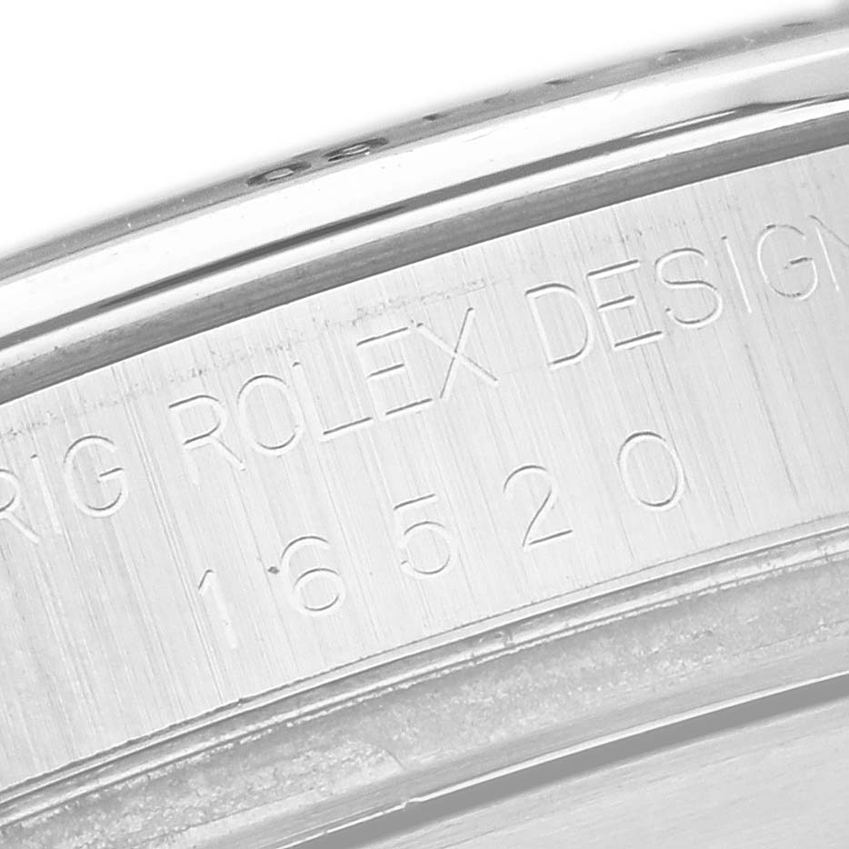 The image shows an angled close-up of the inner bezel with engravings of the model number on the Rolex Daytona 16520 Men's Stainless Steel White Dial 16520 Men's Stainless Steel White Dial watch.