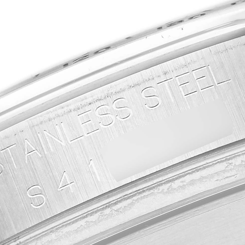 The image shows a close-up of the inner case edge of a Rolex Daytona 16520 Men's Stainless Steel White Dial 16520 Men's Stainless Steel White Dial, highlighting "Stainless Steel" engraving.