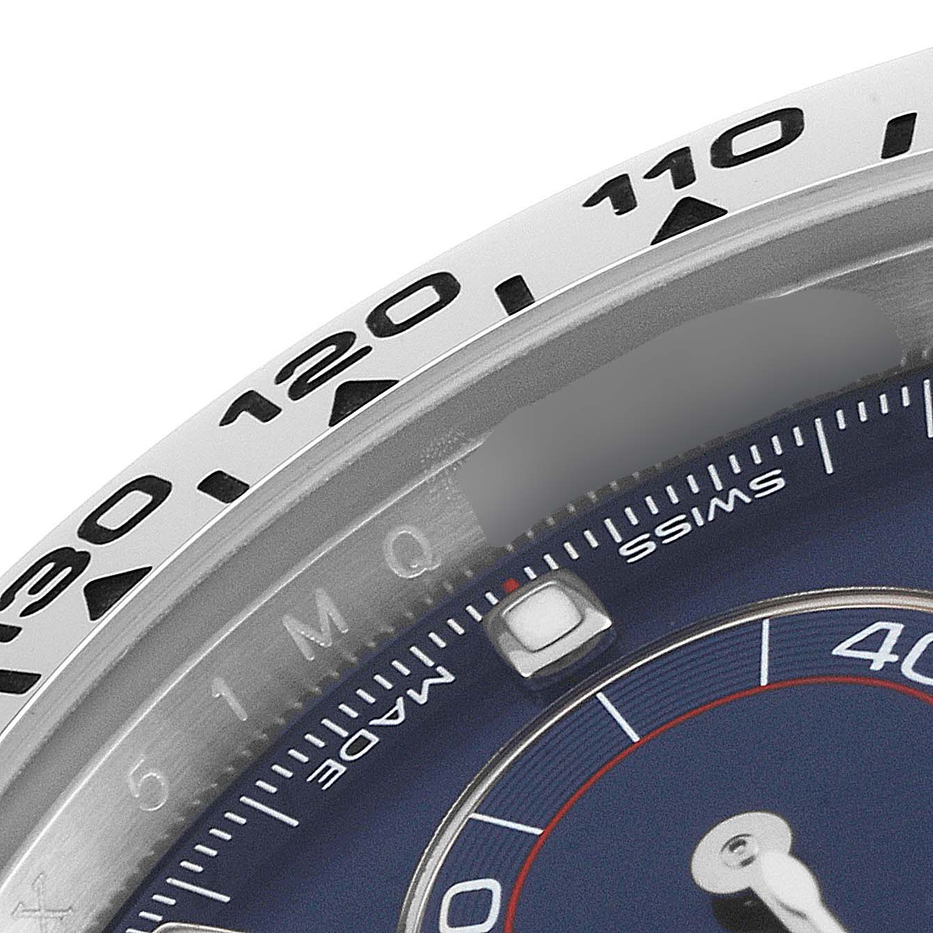 This image shows a close-up of the bezel and a portion of the dial of a Rolex Daytona 116509 Men's White Gold Blue Dial 116509 Men's White Gold Blue Dial watch.