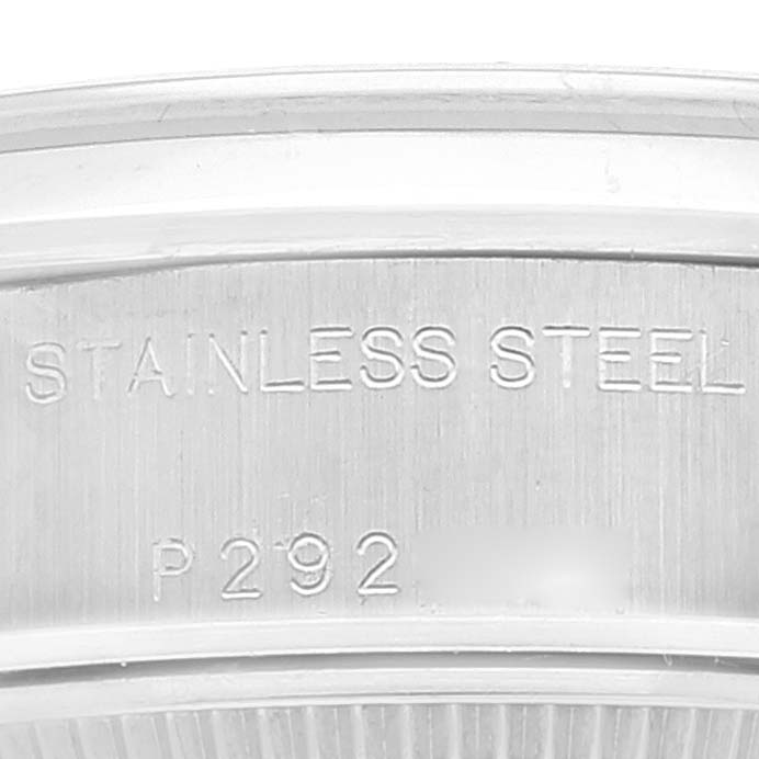 This close-up image shows the inner rim of a Rolex Date 79160 Women's Stainless Steel Pink Dial 79160 Women's Stainless Steel Pink Dial model watch, highlighting the "STAINLESS STEEL" engraving and part of the serial number.