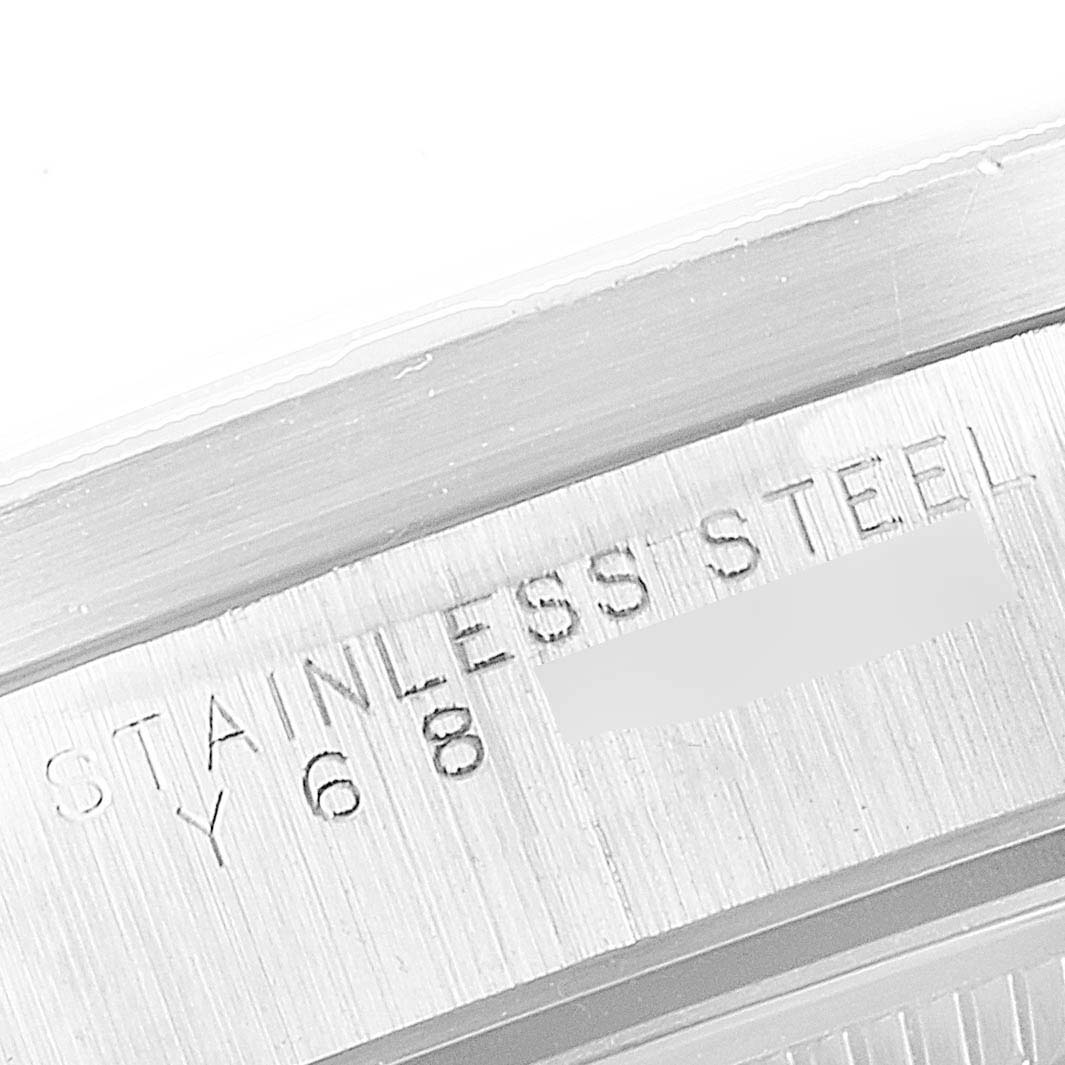 The image shows a close-up of the case back engraving of a Rolex Date 15210 Men's Stainless Steel White Dial 15210 Men's Stainless Steel White Dial model watch, indicating "STAINLESS STEEL" material.