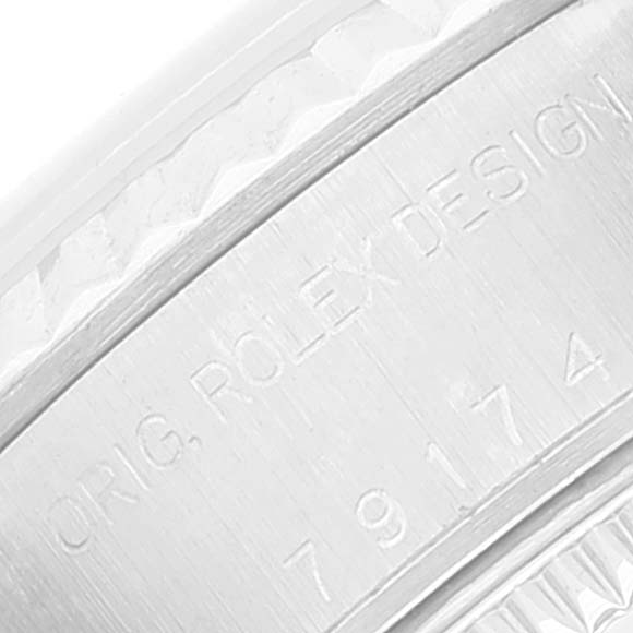This close-up image shows the engraved serial number on the side of the case of a Rolex Datejust 79174 Women's Stainless Steel Pink Dial 79174 Women's Stainless Steel Pink Dial watch.
