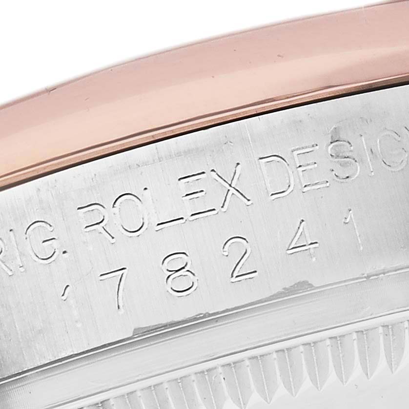 The image shows a close-up of the engraved side of a Rolex Mid-Size 178241 Women's Steel and Gold (two tone) Pink Dial 178241 Women's Steel and Gold (two tone) Pink Dial model watch, focusing on its serial details.