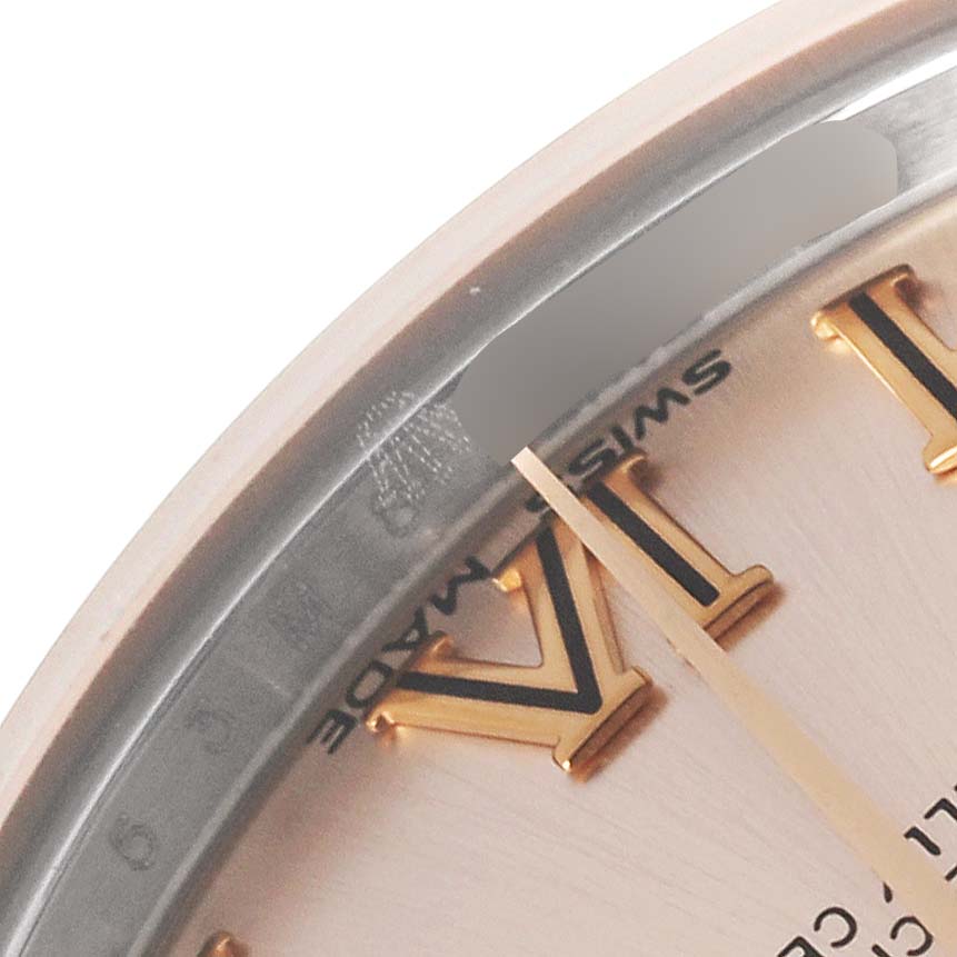 The image shows a close-up of a Rolex Mid-Size 178241 Women's Steel and Gold (two tone) Pink Dial 178241 Women's Steel and Gold (two tone) Pink Dial model watch face, highlighting the bezel, dial, and Roman numeral markers.
