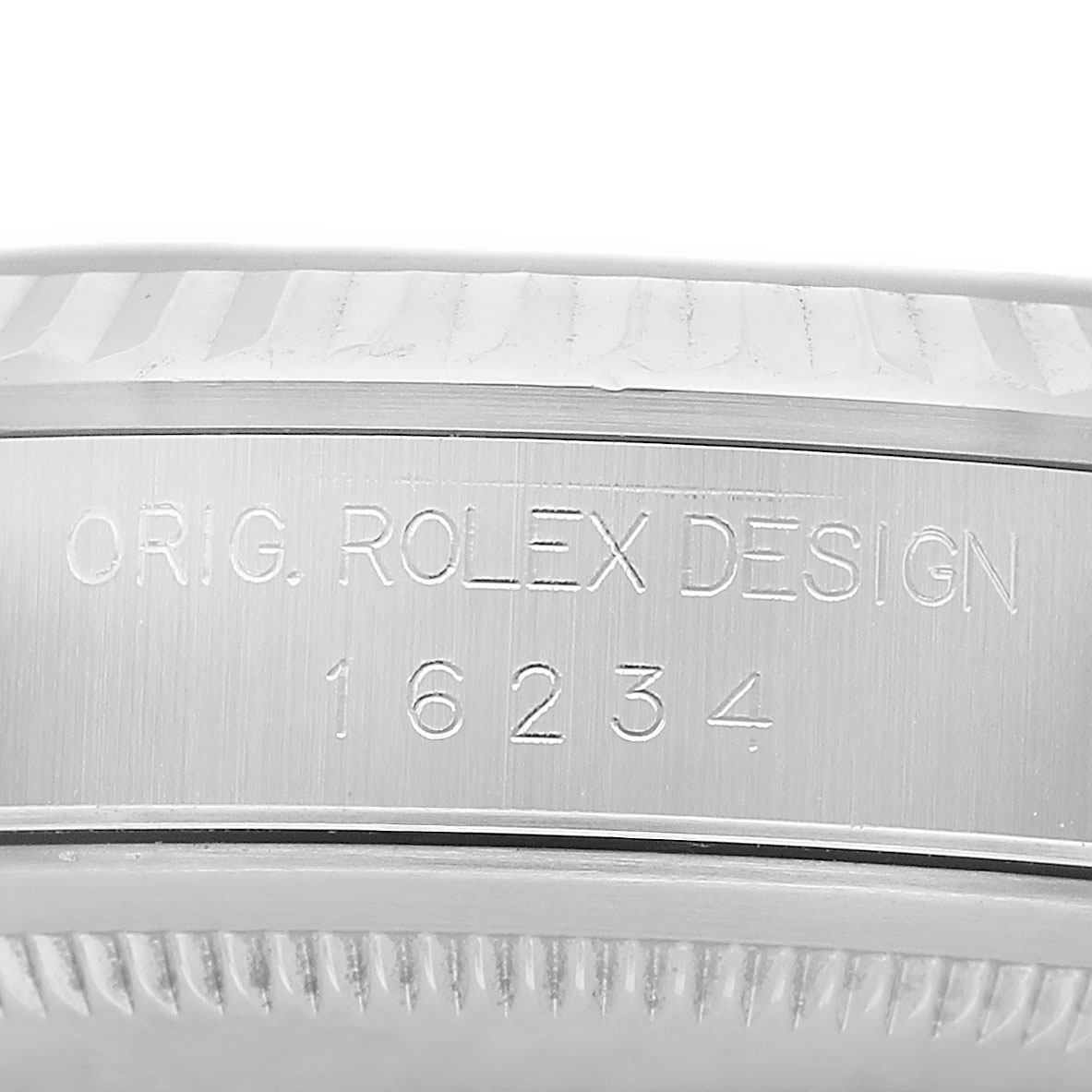 The image shows the engraved side of the case of a Rolex Datejust 16234 Men's Stainless Steel Silver Dial, featuring the model number and design details.
