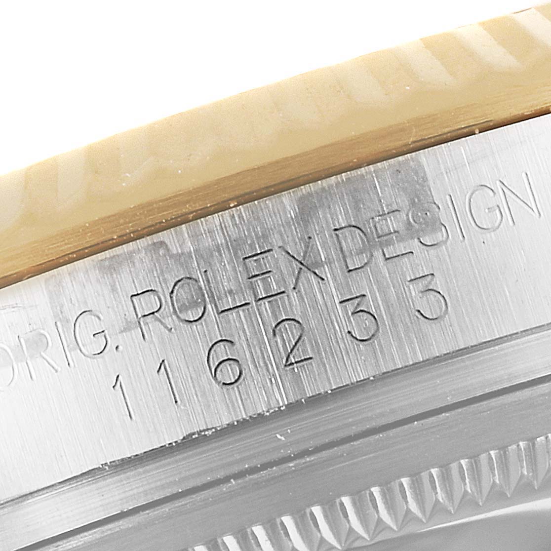 The image shows a close-up of the side of the Rolex Datejust 116233 Men's Steel and Gold (two tone) Champagne Dial 116233 Men's Steel and Gold (two tone) Champagne Dial watch, detailing its engraved model number.