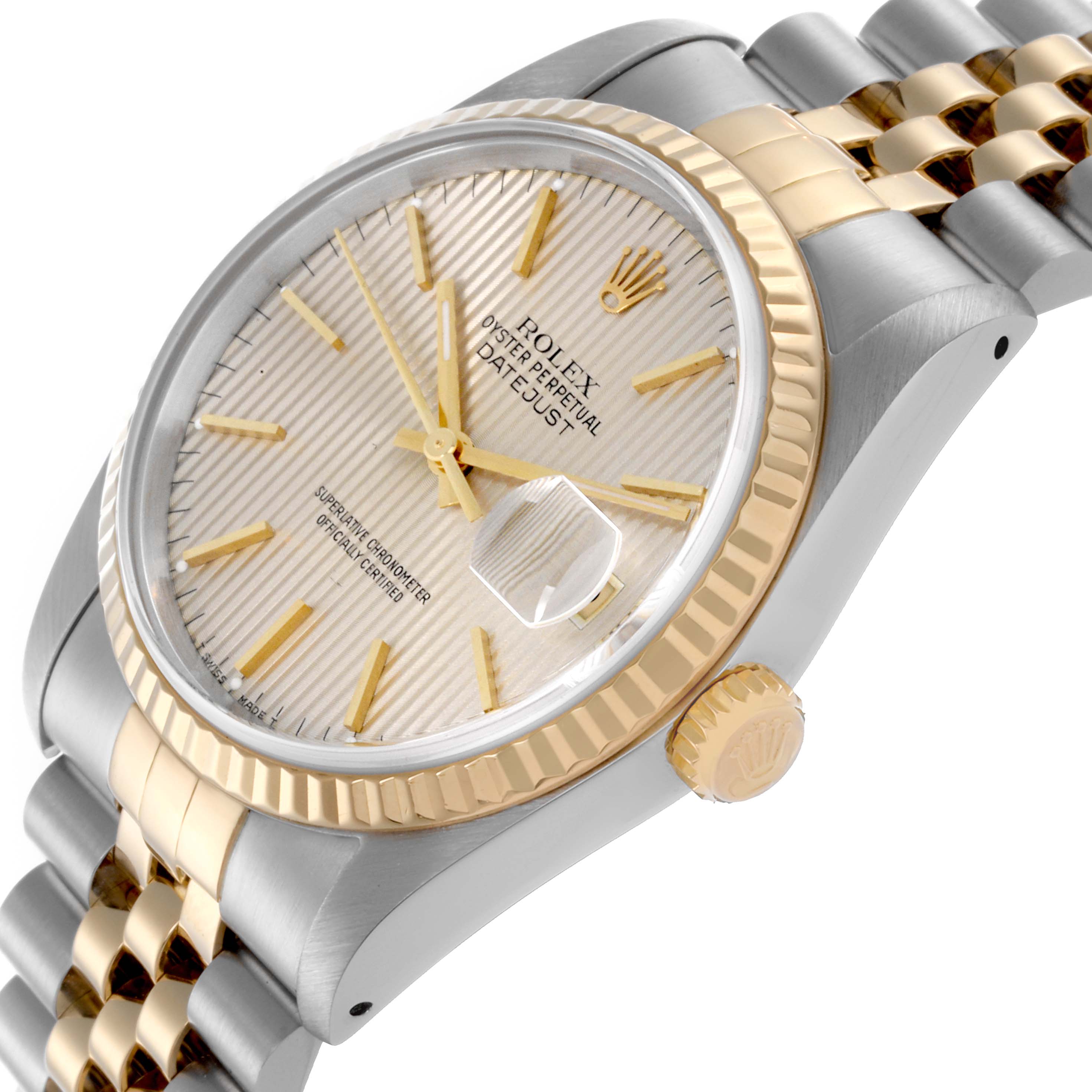The Rolex Datejust 16233 Men
s Steel and Gold (two tone) Silver Dial 16233 Men
s Steel and Gold (two tone) Silver Dial watch is shown at an angle displaying the dial, fluted bezel, crown, and part of the jubilee bracelet.