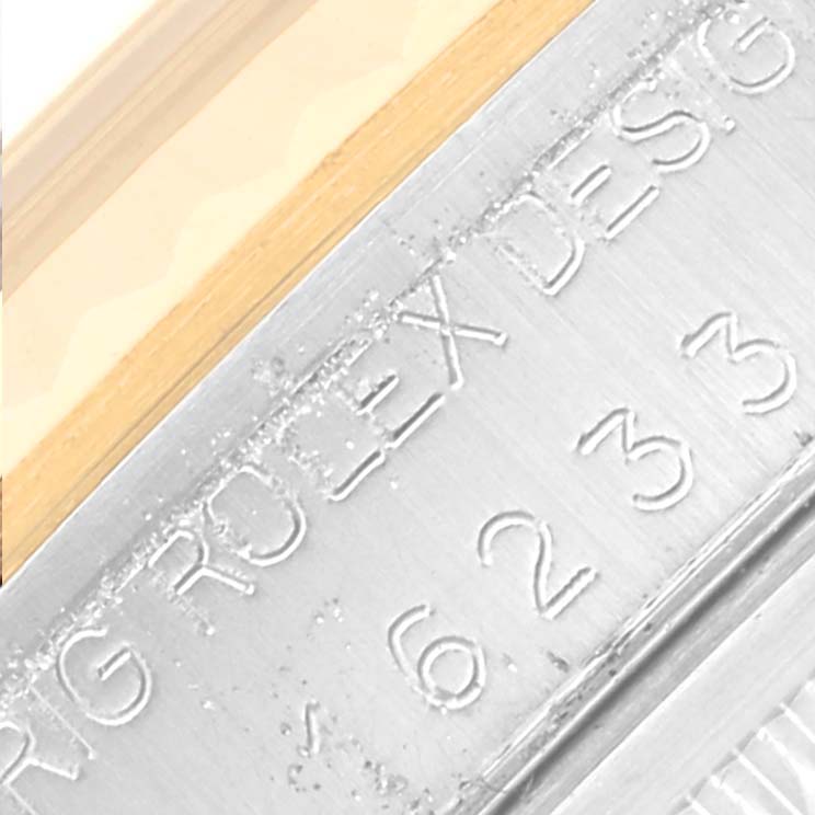 The image shows a close-up of the engraving on the side of a Rolex Datejust 16233 Men
s Steel and Gold (two tone) Silver Dial 16233 Men
s Steel and Gold (two tone) Silver Dial watch case.