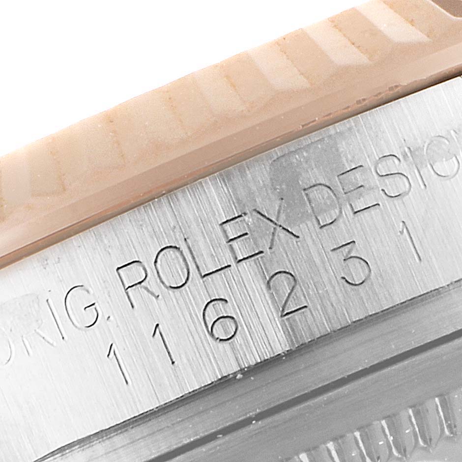 This close-up image shows the engraved model number and part of the bezel of a Rolex Datejust 116231 Men's Steel and Gold (two tone) Pink Dial 116231 Men's Steel and Gold (two tone) Pink Dial watch.