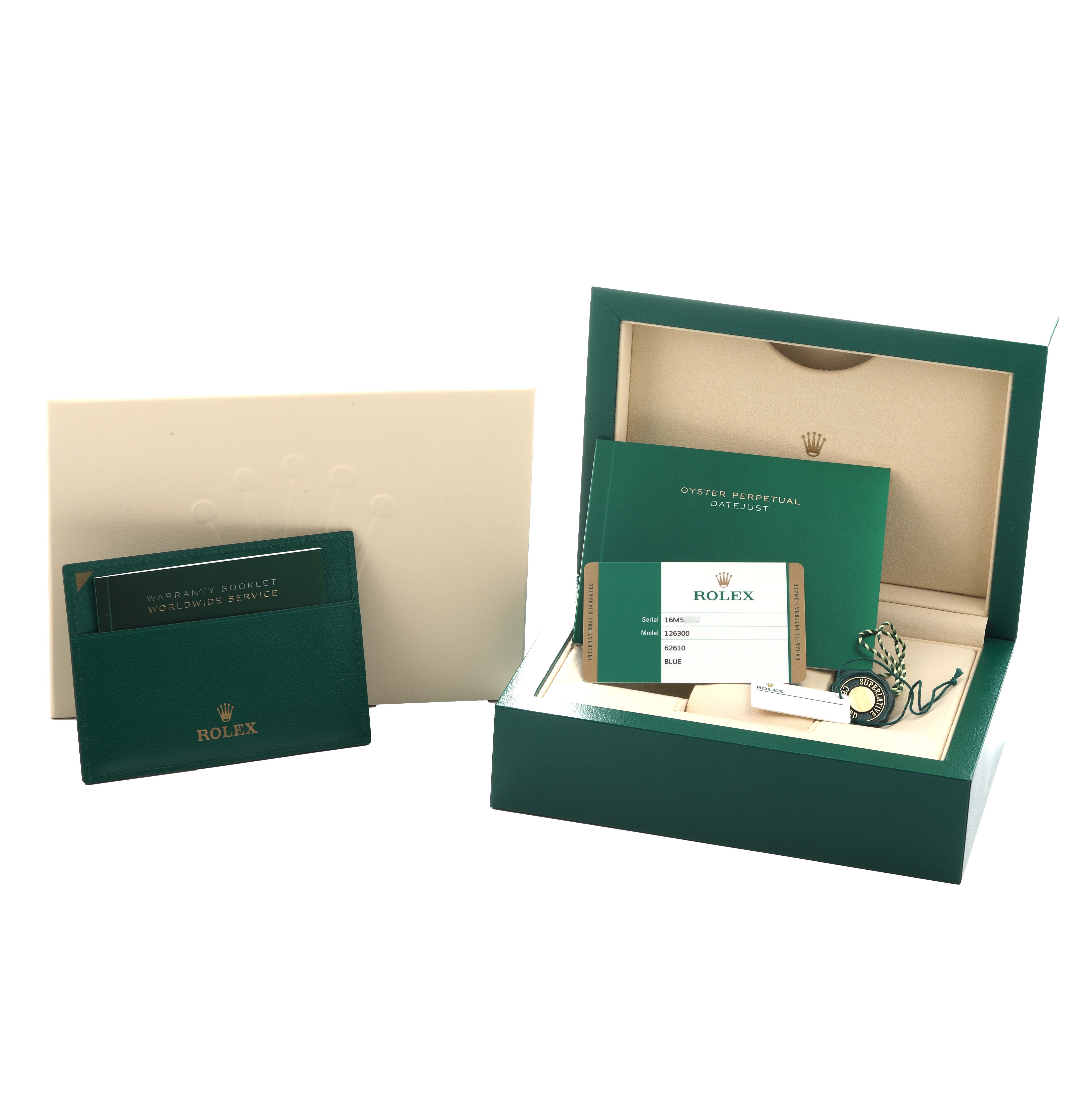 The image shows a Rolex Datejust 41 126300 Men
s Stainless Steel Blue Dial watch box with accessories, including booklets, warranty card, and green seal, all from a frontal angle.