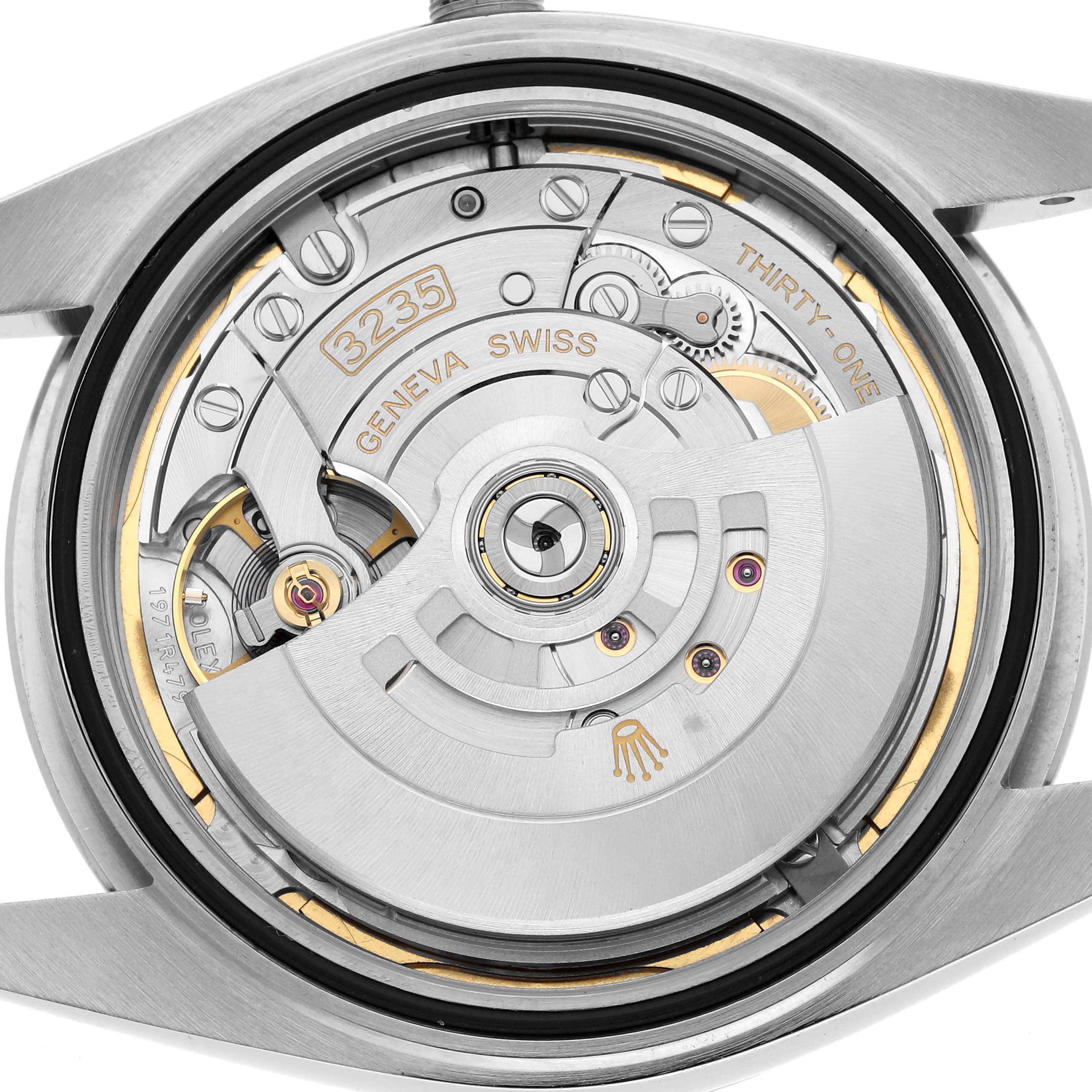 The image shows the Rolex Datejust 41 126300 Men
s Stainless Steel Blue Dial
s movement from the back, highlighting the rotor and internal mechanisms.