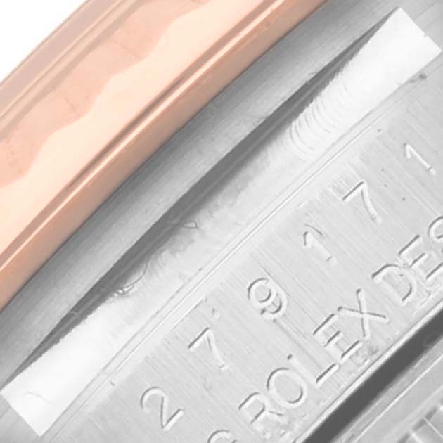 The image shows a close-up of the Rolex Datejust 279171 Women's Steel and Gold (two tone) Brown Dial 279171 Women's Steel and Gold (two tone) Brown Dial model's bezel and engraved inner case.