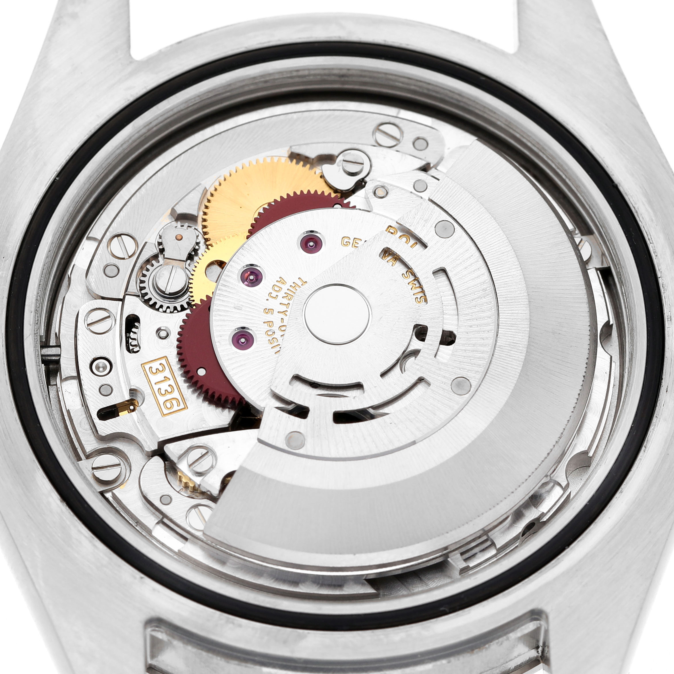 The image shows the inner movement of a Rolex Datejust 41 116334 Men's Stainless Steel White Dial watch, highlighting gears and mechanical components from the back.