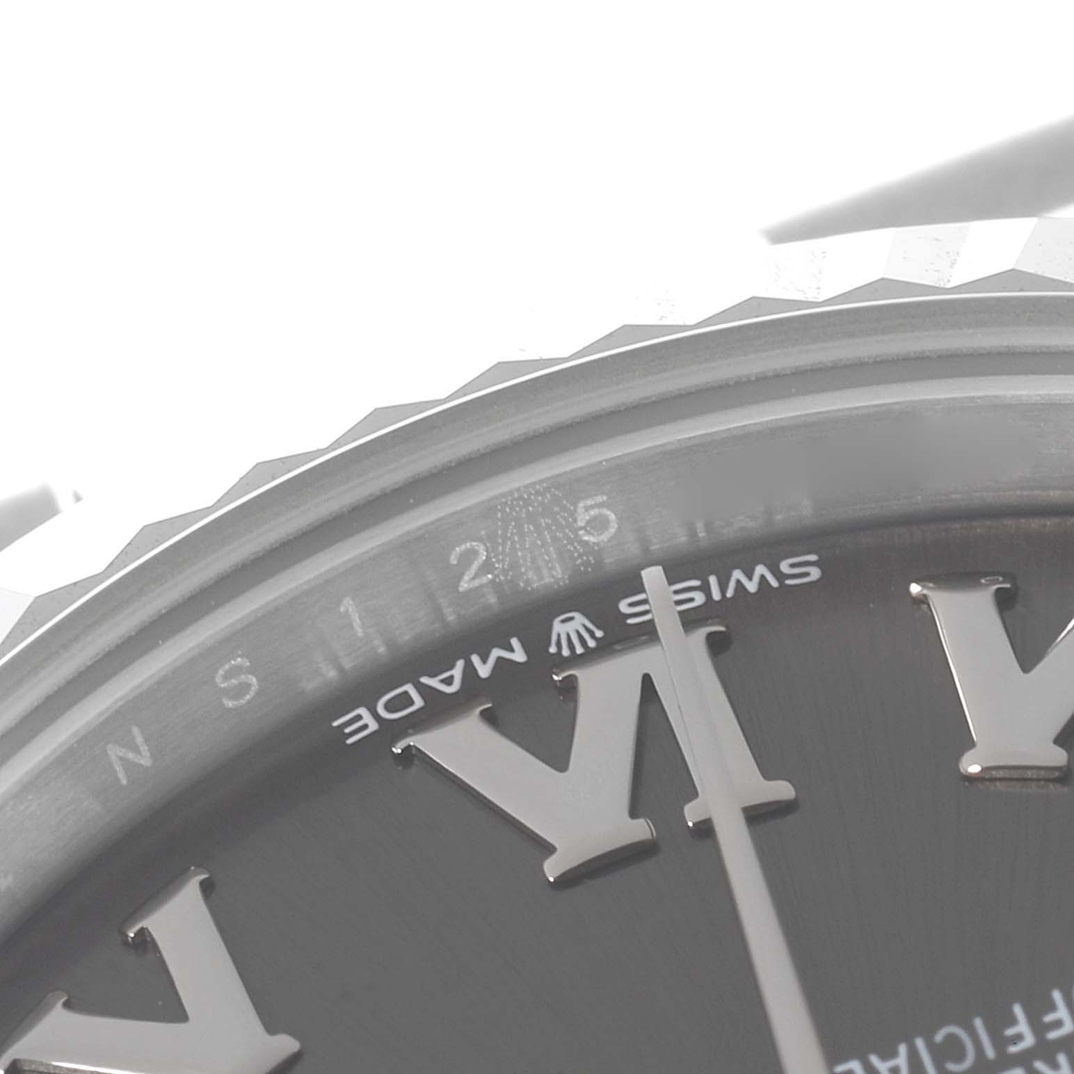 The image shows a close-up of the dial and bezel of a Mid-Size Rolex watch, highlighting the Roman numeral "VI" and "SWISS MADE" text.