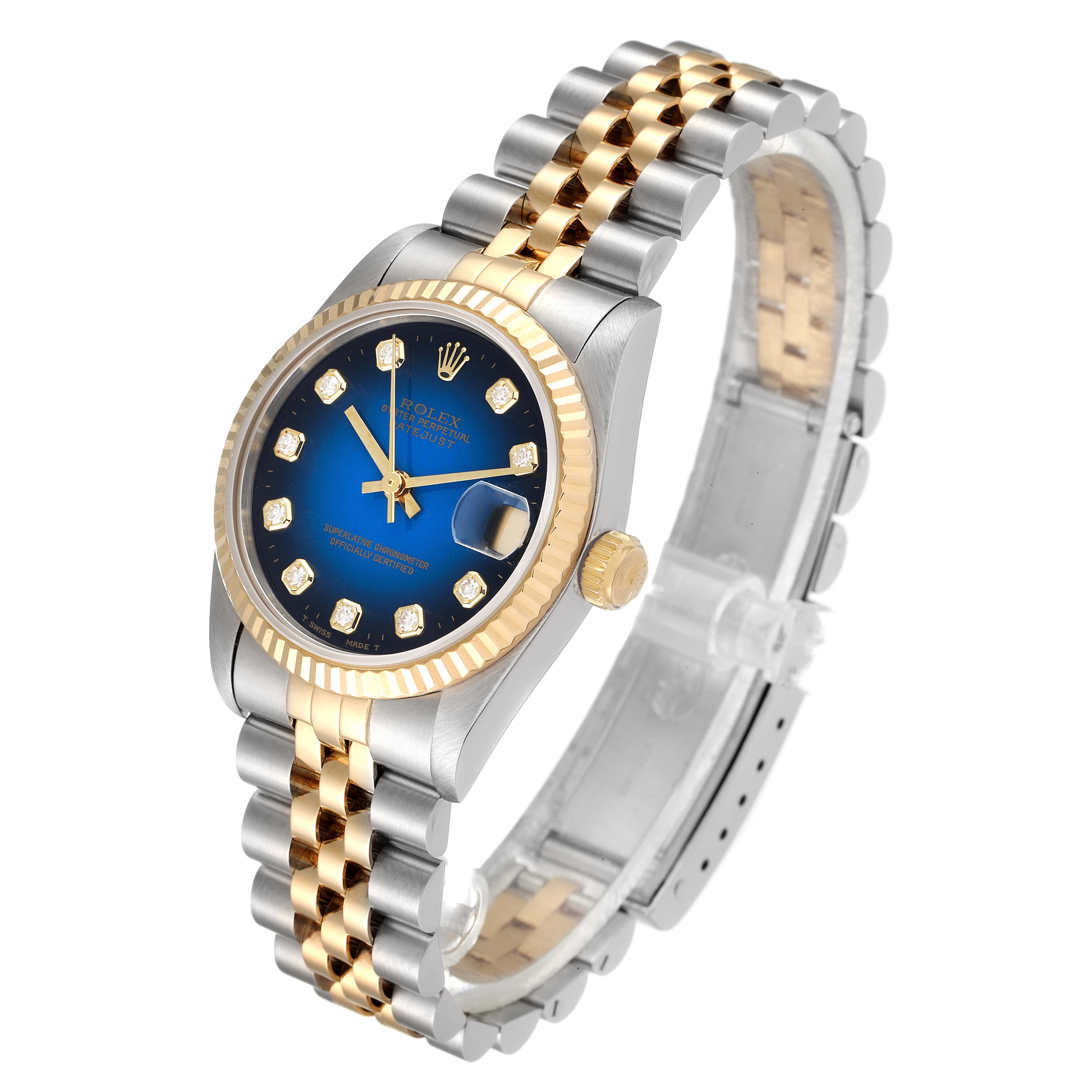 The image shows a Rolex Mid-Size 68273 Women's Steel and Gold (two tone) Blue Dial 68273 Women's Steel and Gold (two tone) Blue Dial watch with a gold and silver Jubilee bracelet, a gold fluted bezel, blue dial, and diamond hour markers.