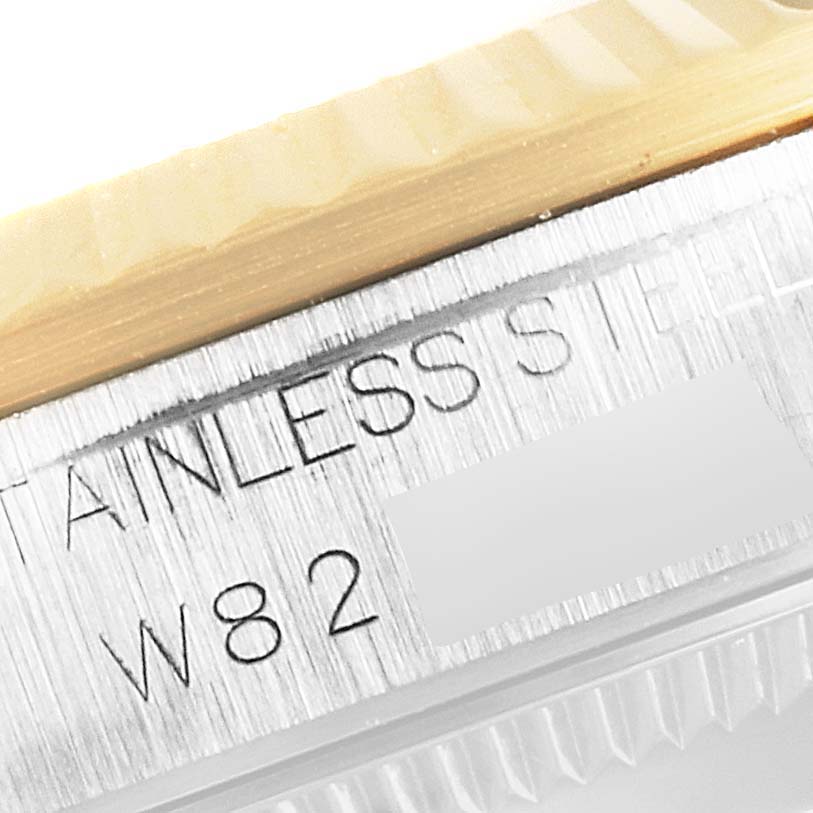 The image shows a close-up of the side of a Rolex Mid-Size 68273 Women's Steel and Gold (two tone) Blue Dial 68273 Women's Steel and Gold (two tone) Blue Dial watch showing "STAINLESS STEEL" and part of the serial number.