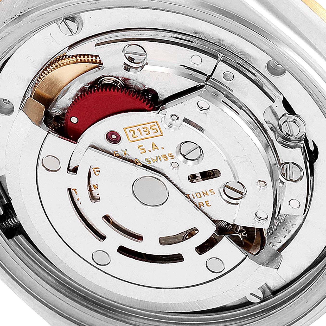 The image shows the internal movement mechanism of a Mid-Size Rolex watch from a close-up angle.