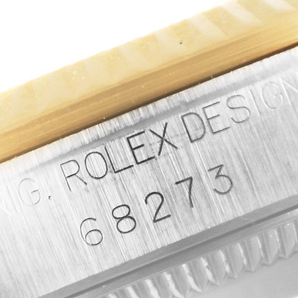 This image shows a close-up of the side case with "Rolex Design" and the model number 68273 of a Mid-Size Rolex watch.