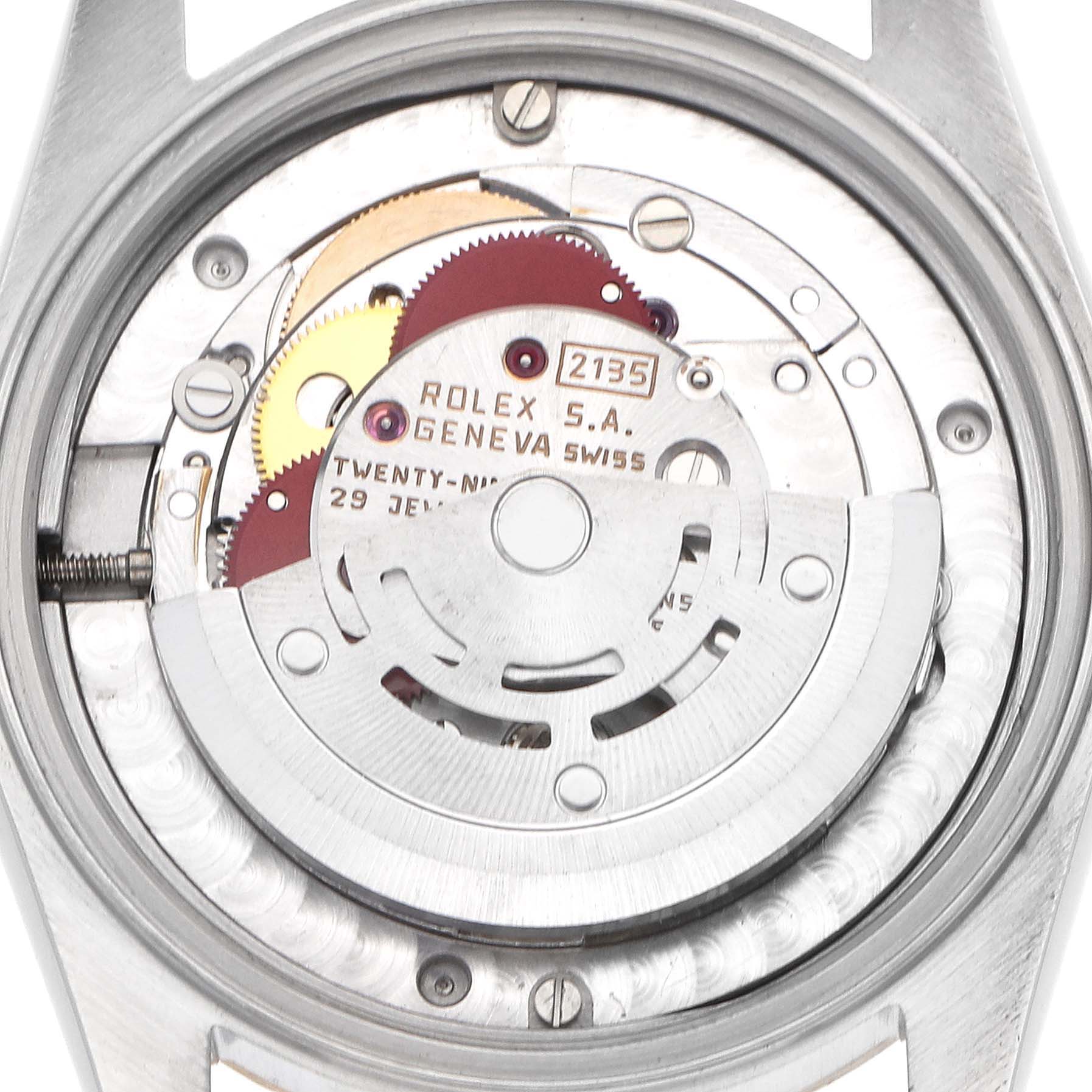 The image shows the movement of a Mid-Size Rolex watch from a top-down angle, displaying gears and the rotor.