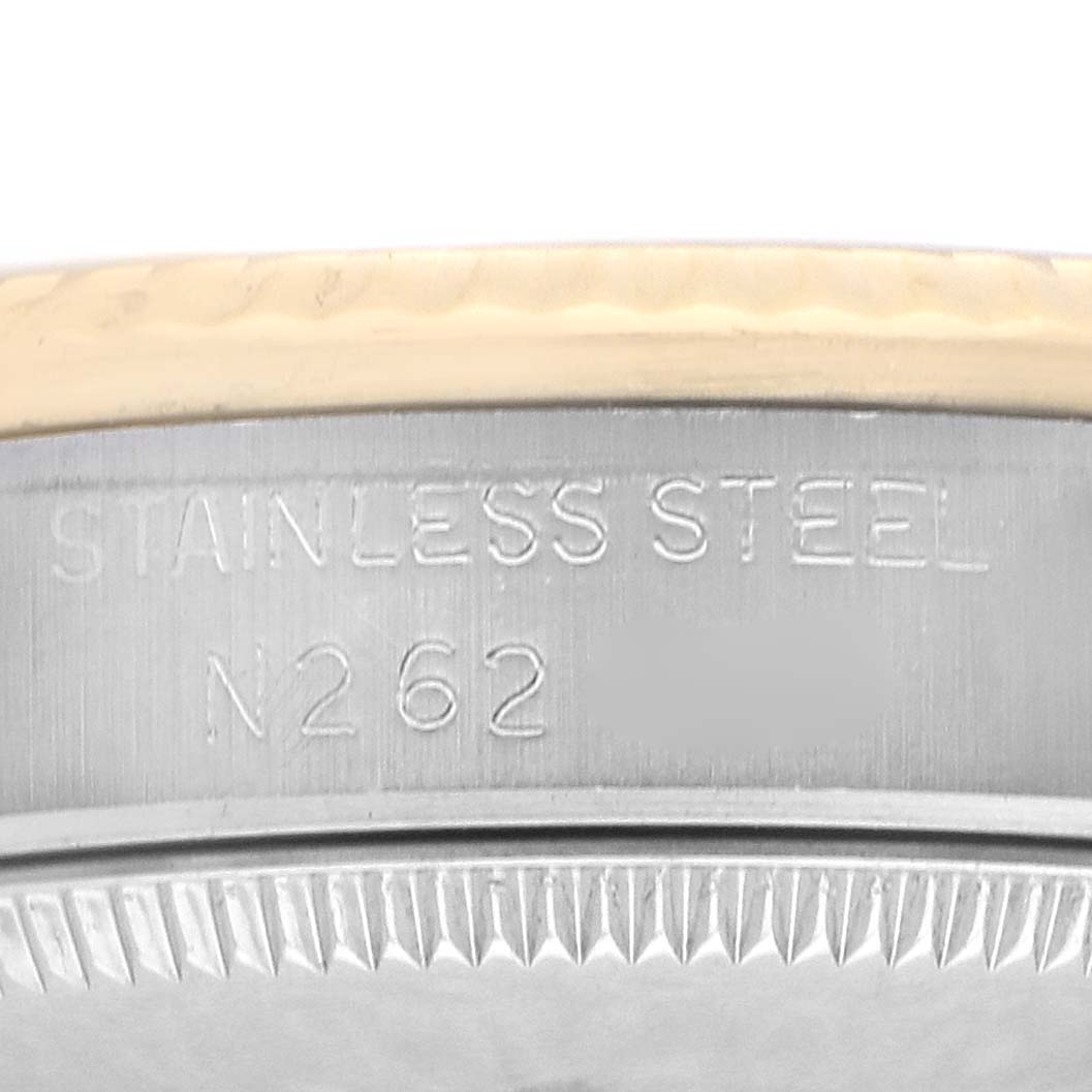 The image shows a close-up of the stainless steel case side for a Rolex Mid-Size 68273 Women's Steel and Gold (two tone) Champagne Dial watch, featuring engravings.
