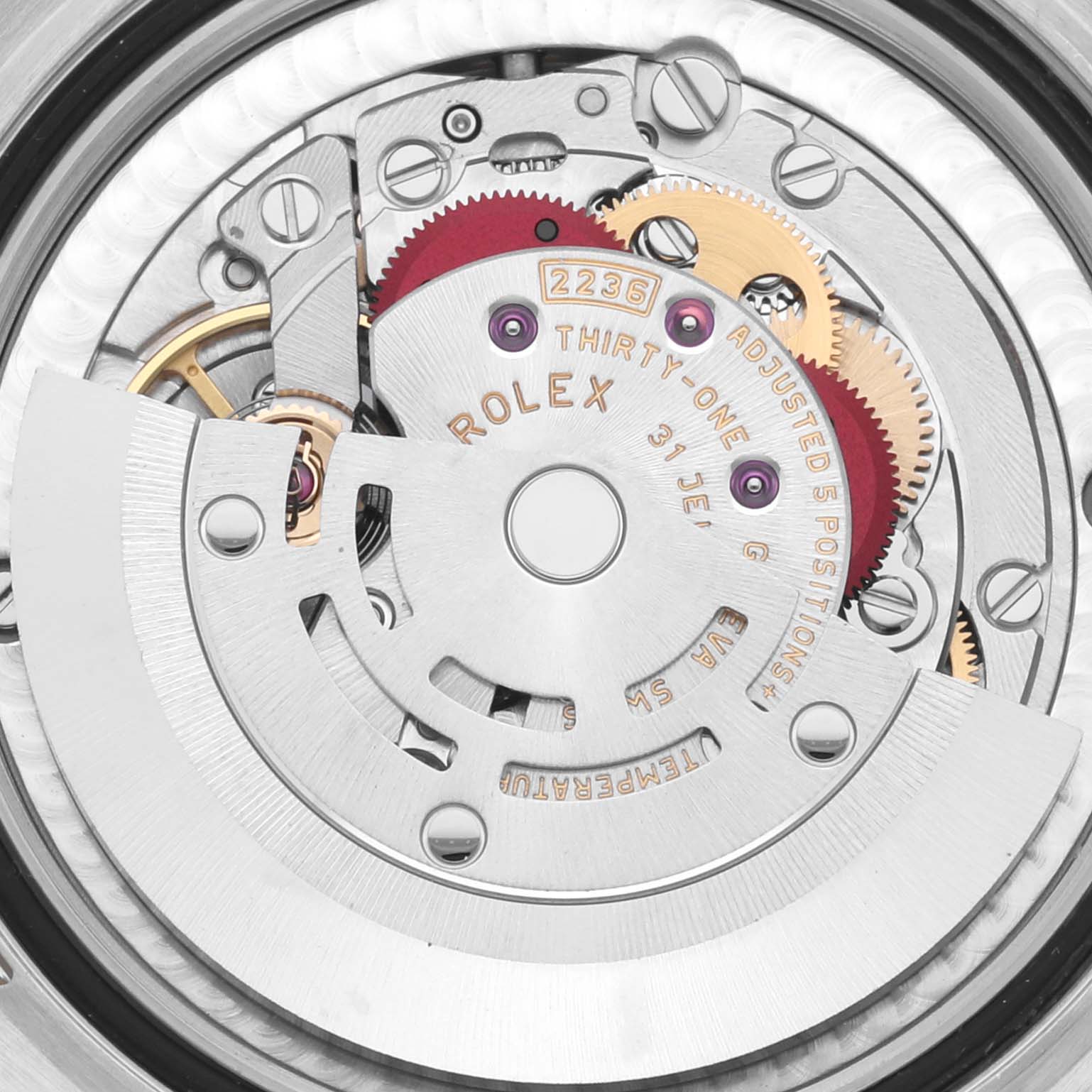 This image shows the internal mechanism of a Rolex Mid-Size 278343RBR-0030 Women's Steel and Gold (two tone) Green Dial 278343RBR-0030 Women's Steel and Gold (two tone) Green Dial watch, highlighting gears and the rotor from the back view.