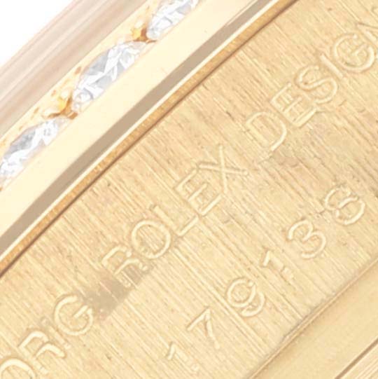 The image shows a close-up of the engraved edge of the Rolex President 179138 Women's Yellow Gold Champagne Dial 179138 Women's Yellow Gold Champagne Dial watch, featuring the model number and design details.