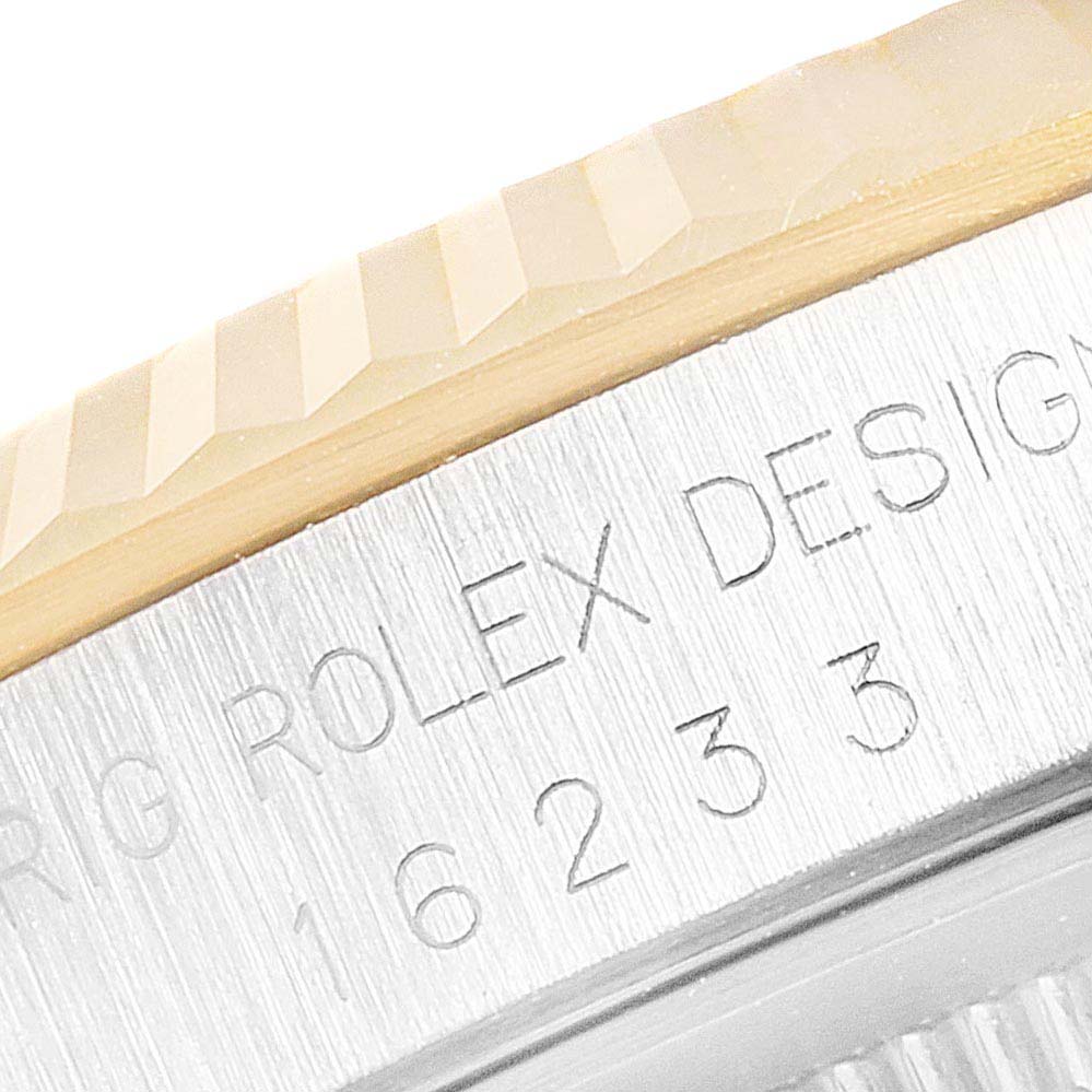 This close-up image shows the engraved case with the model number and the fluted bezel of the Rolex Datejust 16233G Men's Steel and Gold (two tone) Champagne Dial 16233G Men's Steel and Gold (two tone) Champagne Dial watch.