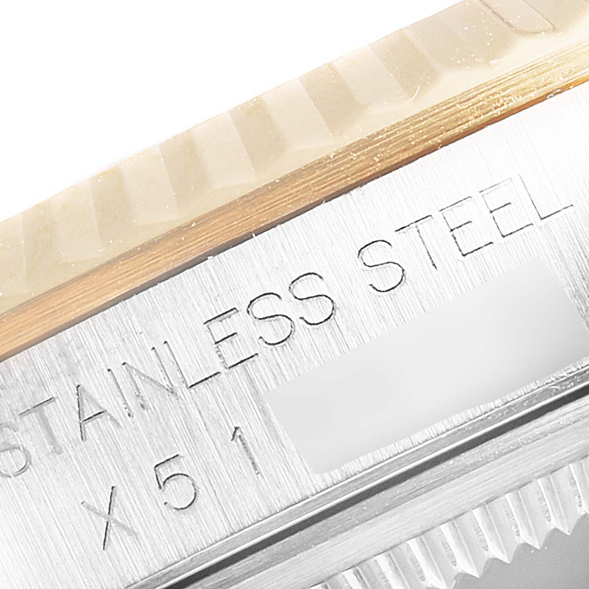 The image shows a close-up of the side of the bezel and case with "STAINLESS STEEL" engraving on a Rolex Datejust 16233 Men
s Steel and Gold (two tone) Champagne Dial 16233 Men
s Steel and Gold (two tone) Champagne Dial watch.